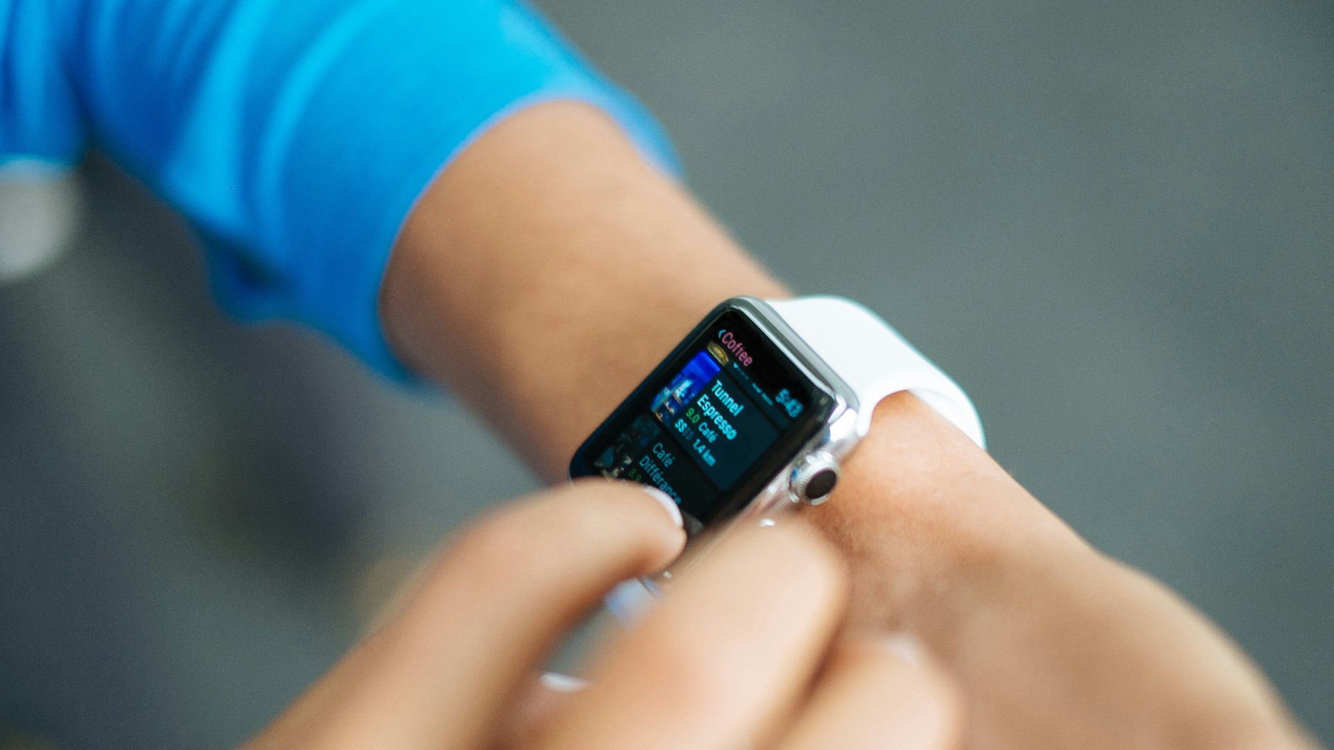 person wearing silver Apple Watch with white Sport Band