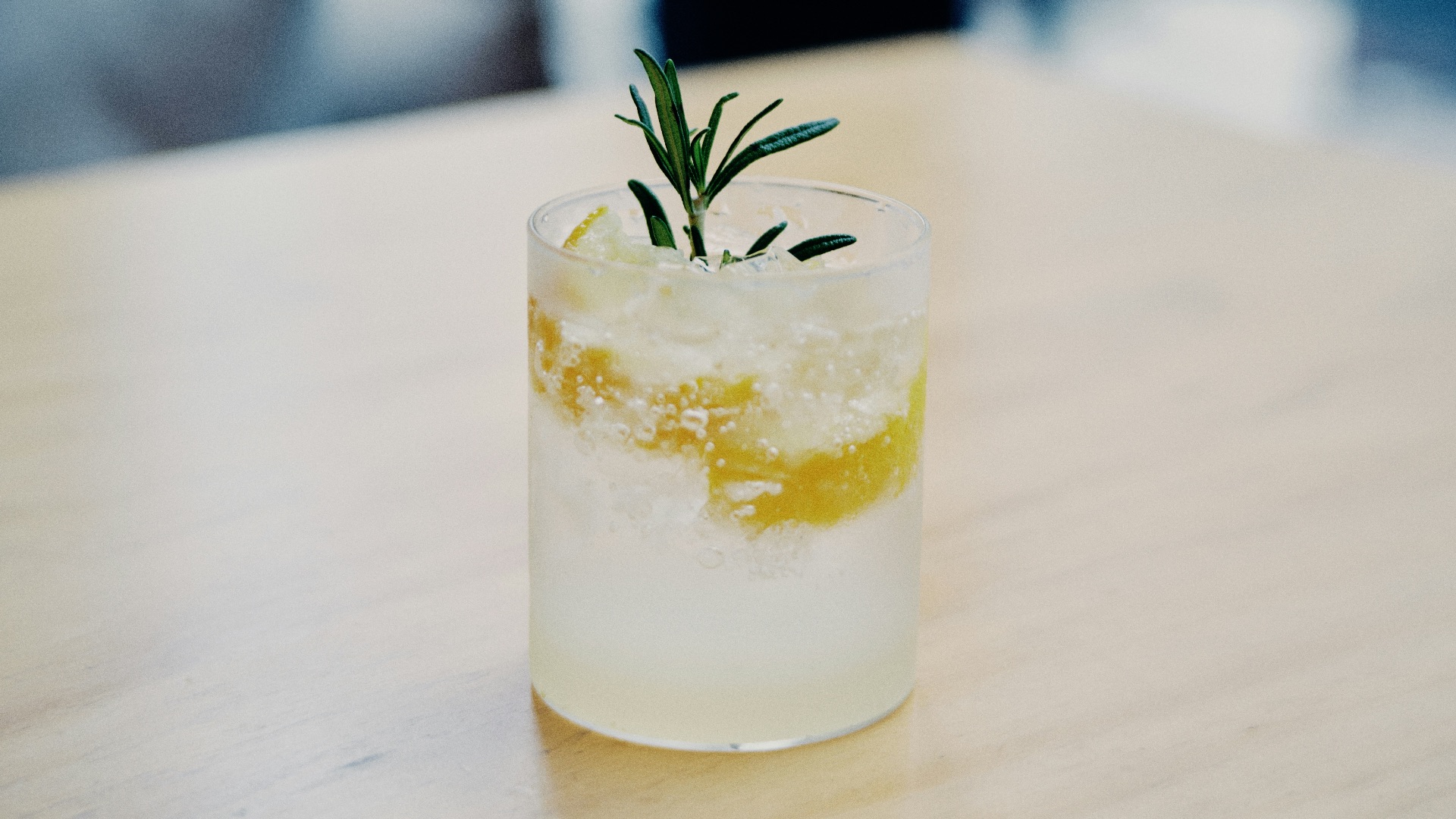 clear drinking glass with white liquid and green leaf