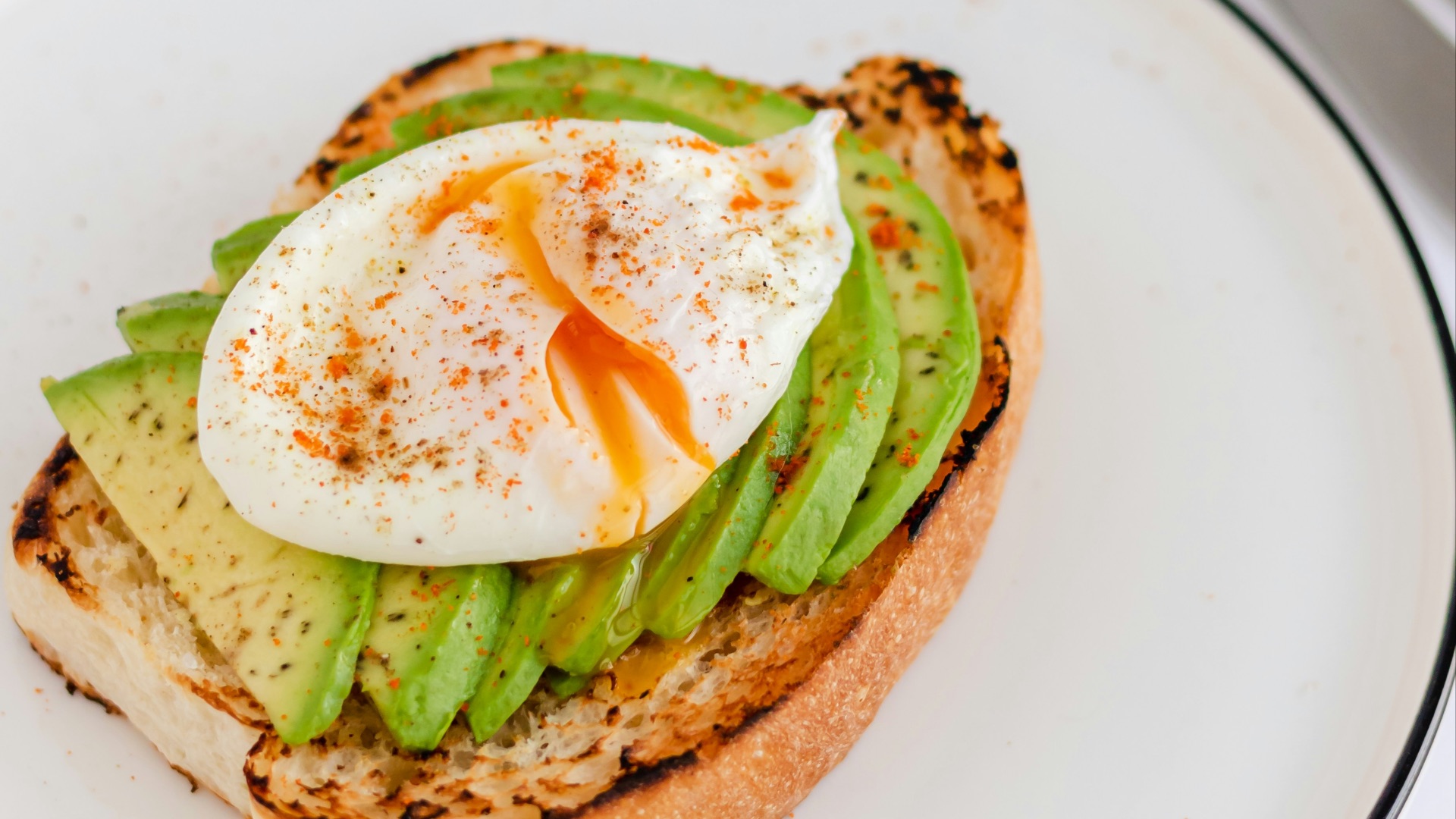 a sandwich with an egg and asparagus on it