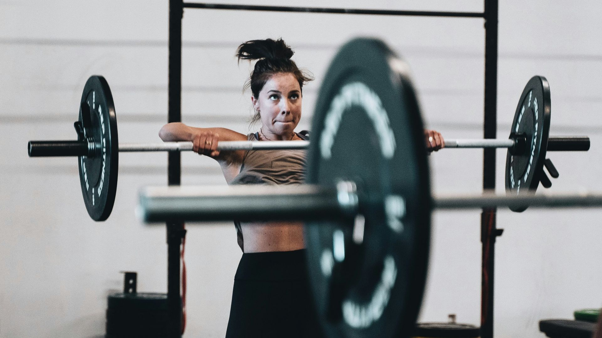 woman in black leggings and black tank top doing exercise
