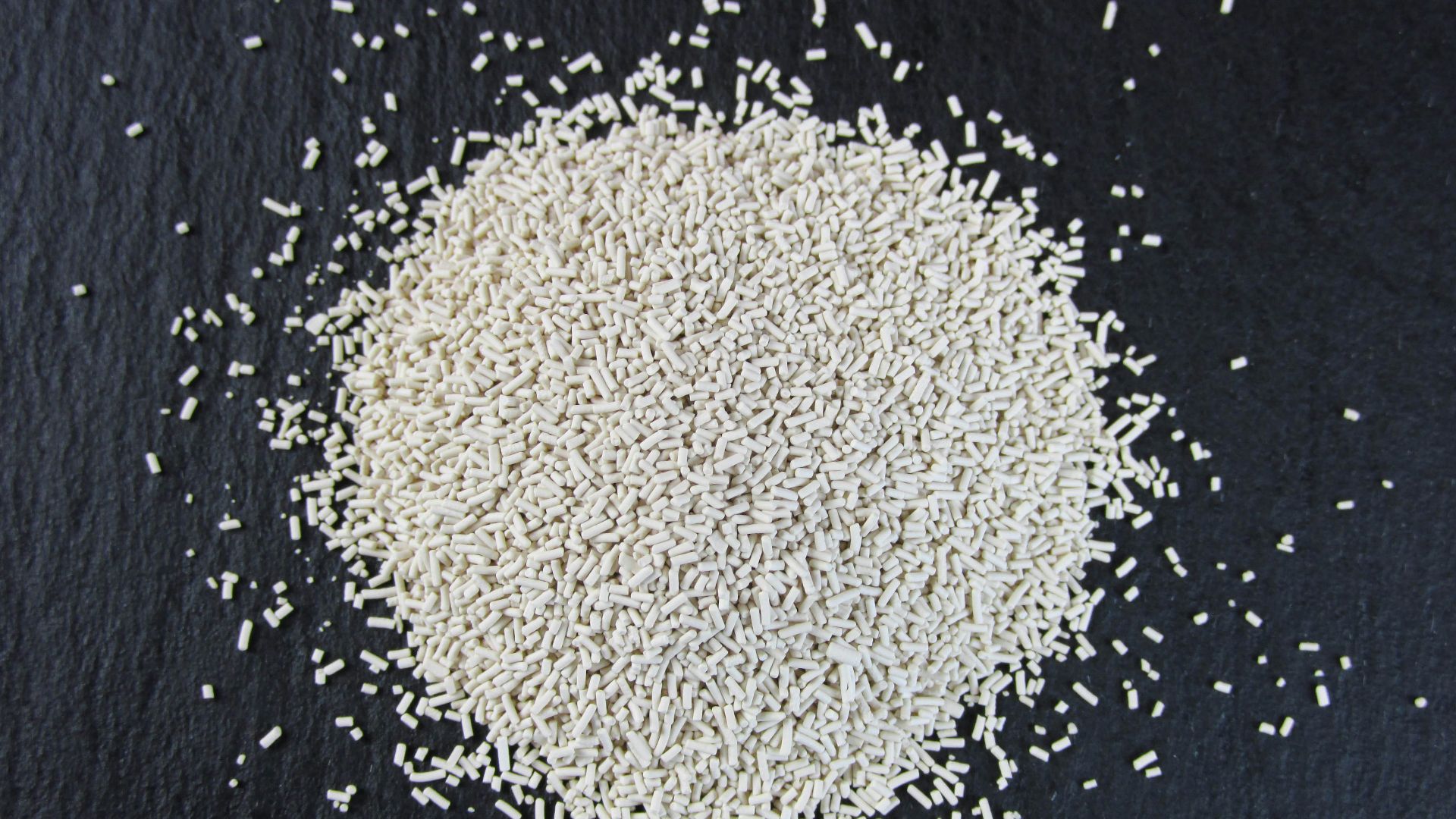 a pile of white rice sitting on top of a black surface