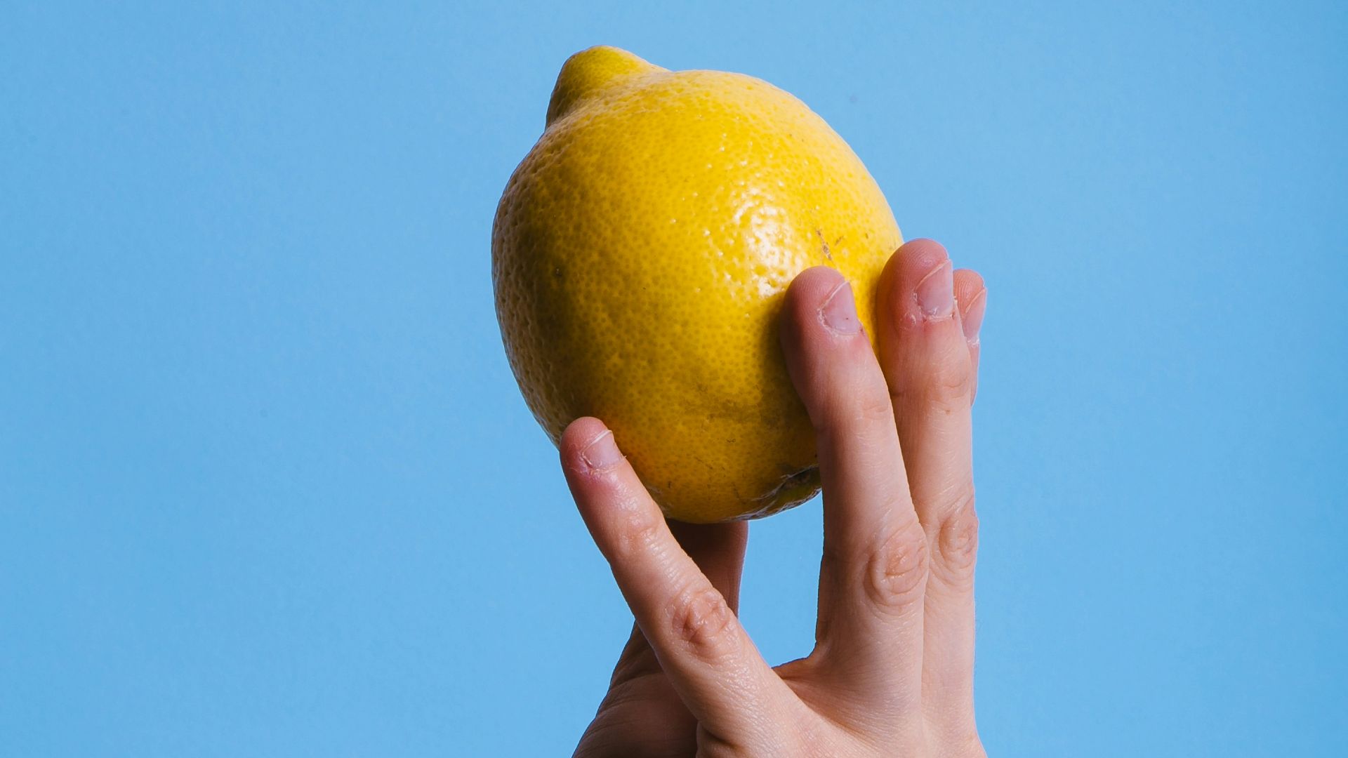 person holding lemon