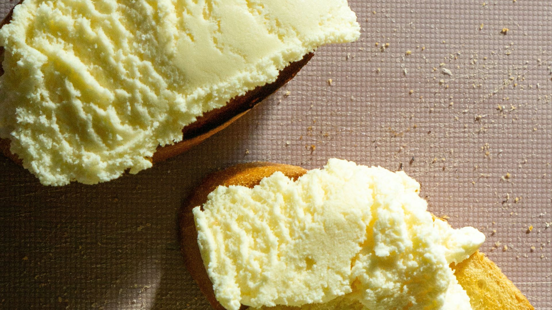 bread with butter on black and white polka dot textile