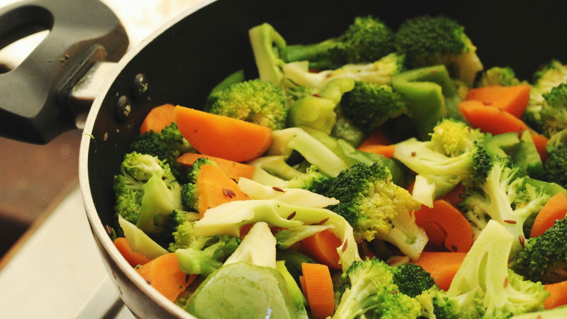 green and orange vegetable salad in white ceramic bowl