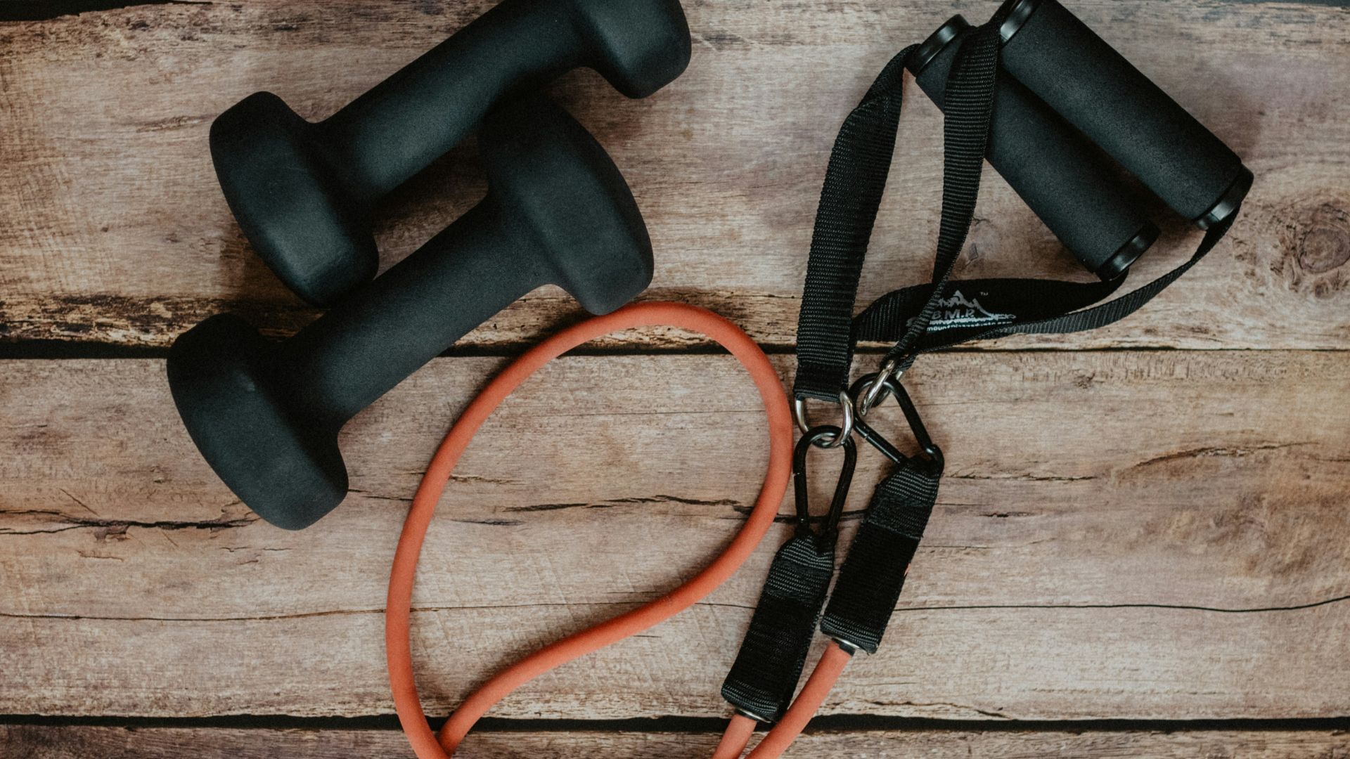 orange and black usb cable on brown wooden surface