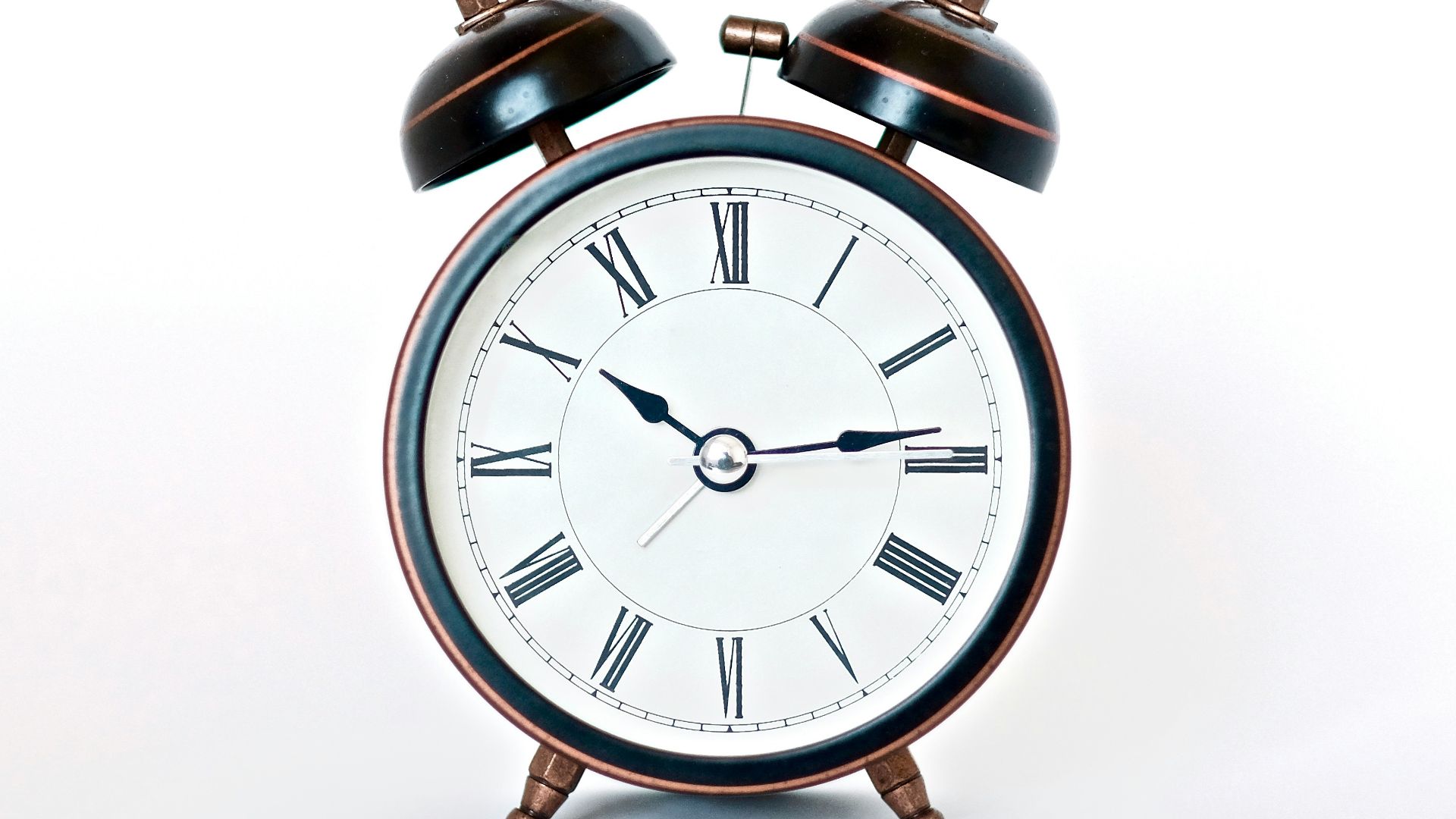 round black and white analog alarm clock