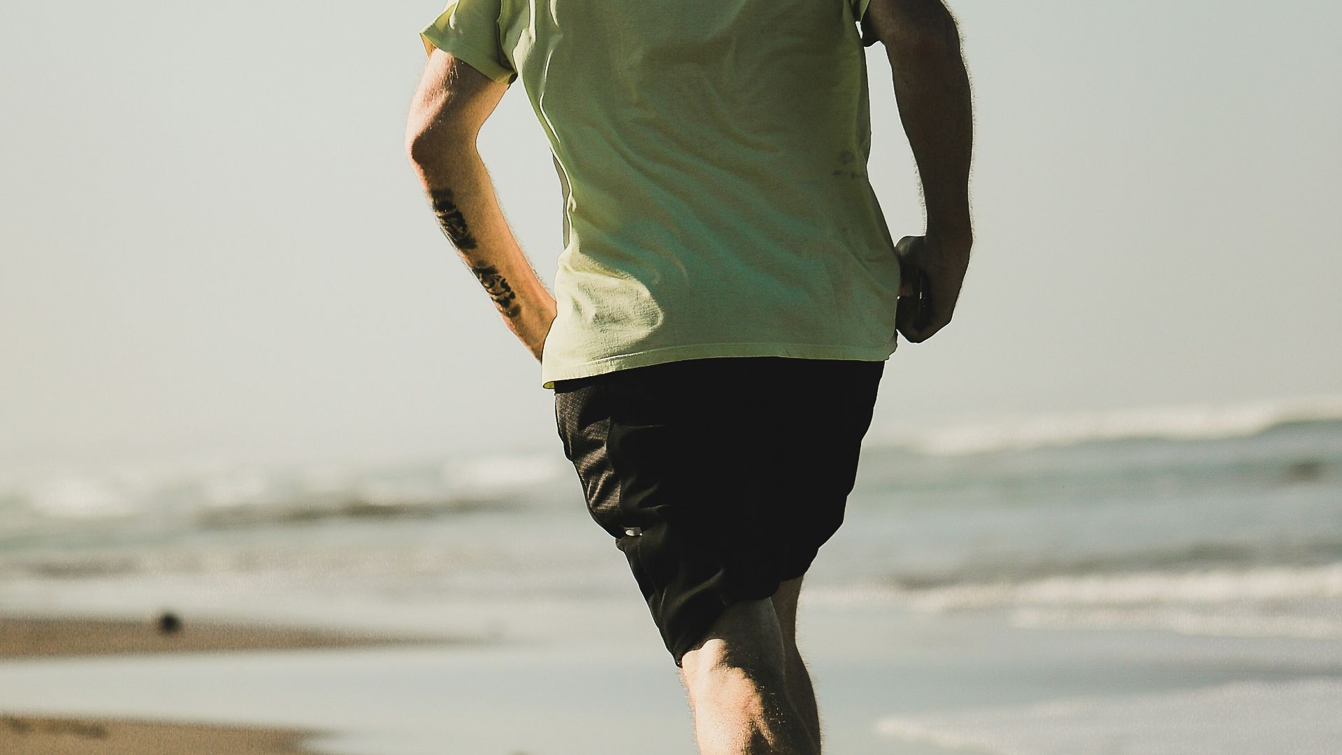 man running on seashore