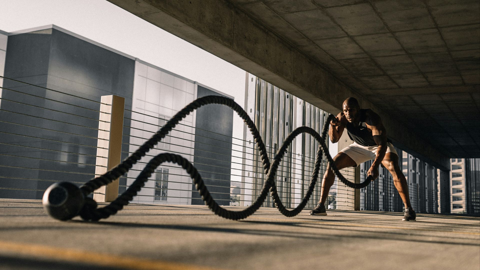 woman in black tank top sitting on brown wooden bench