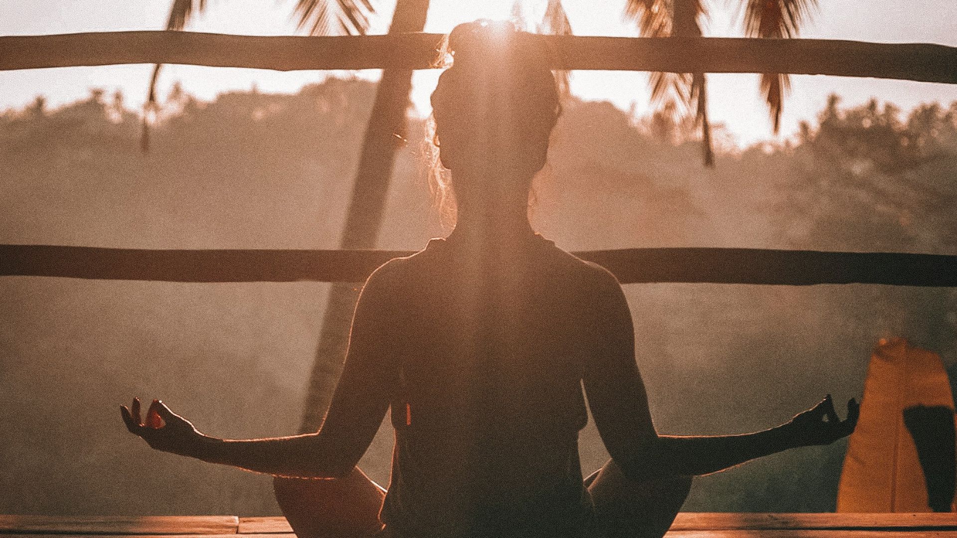 woman doing yoga meditation on brown parquet flooring