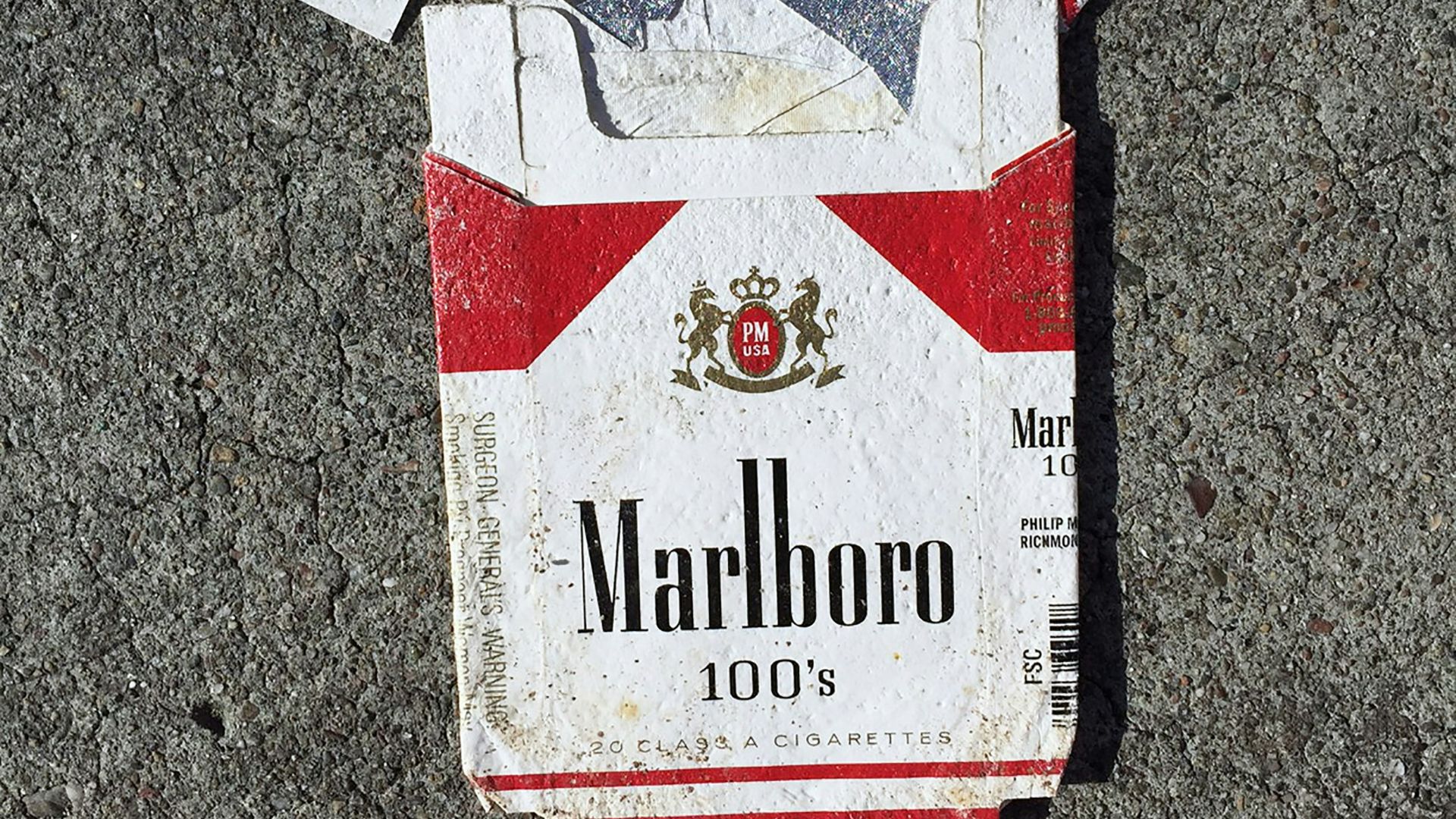 red Marlboro cigarette box on gray surface