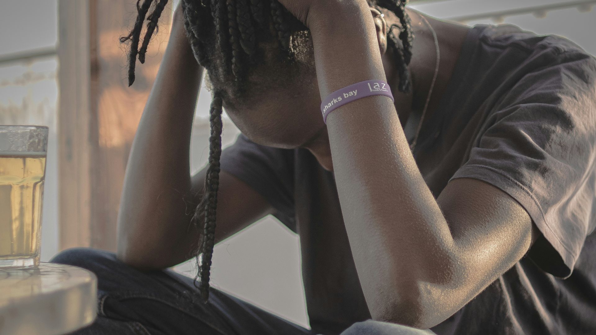 A man sitting on a chair with his head in his hands