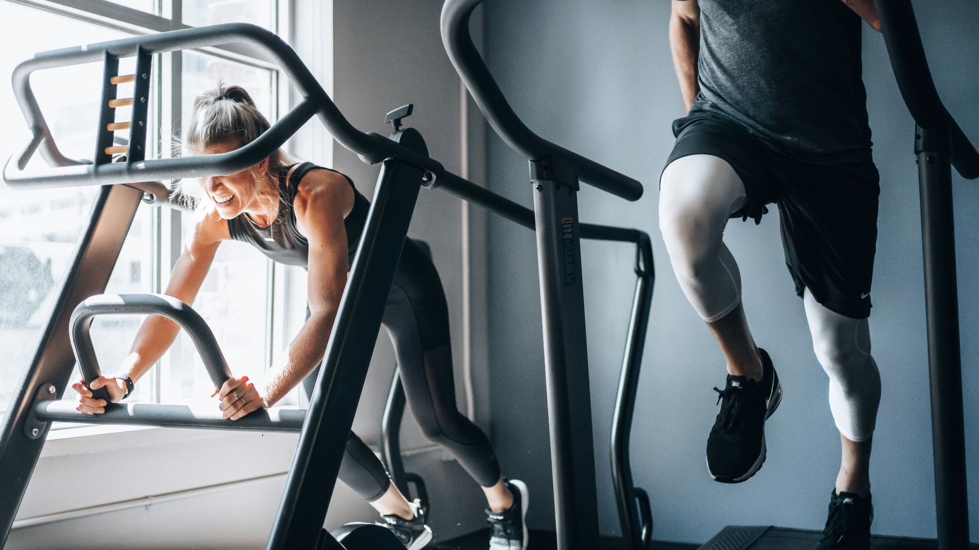 woman in black tank top and black shorts sitting on black exercise equipment