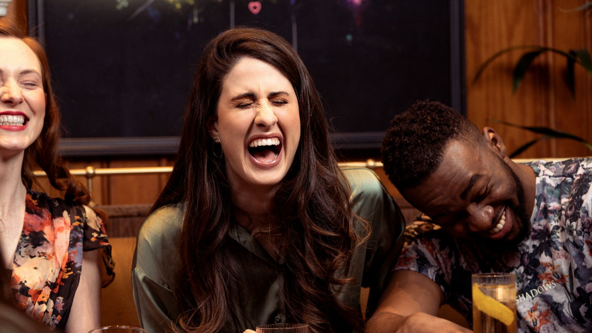 a group of people sitting around a table with drinks