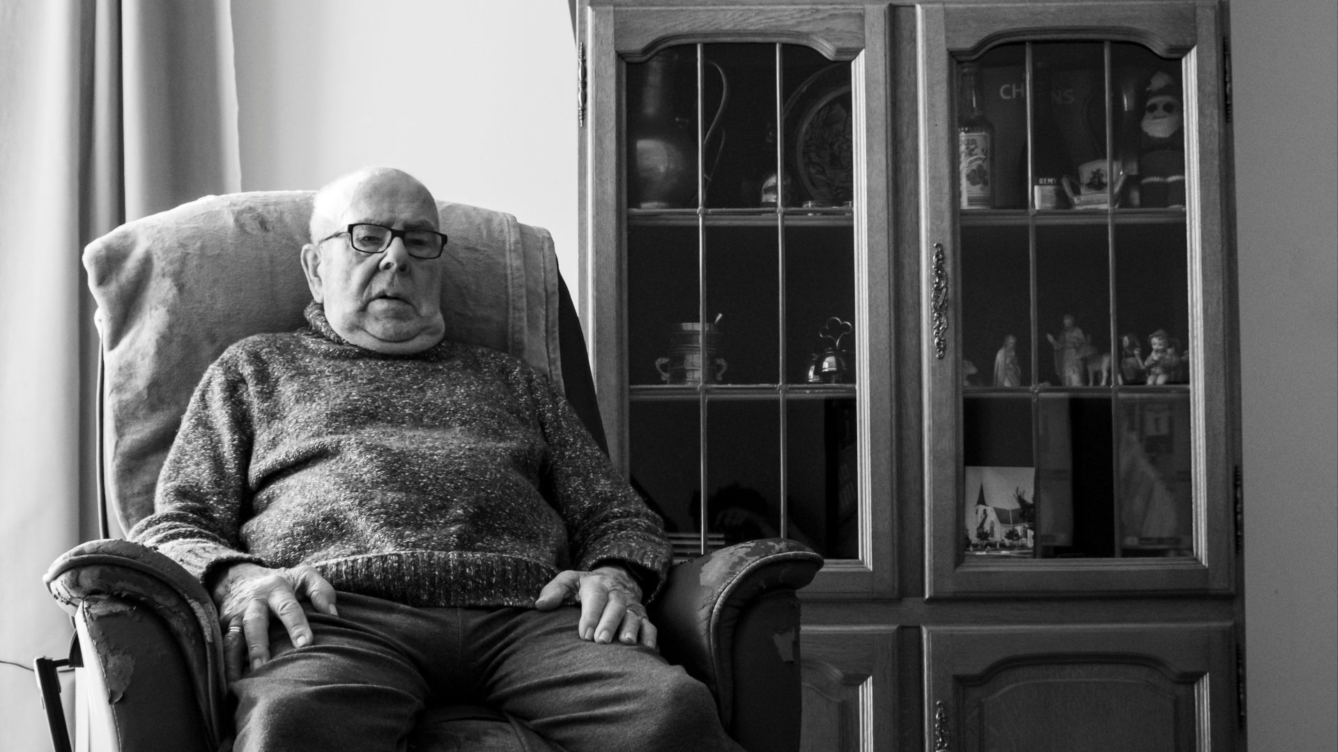 man in sweater sitting on chair
