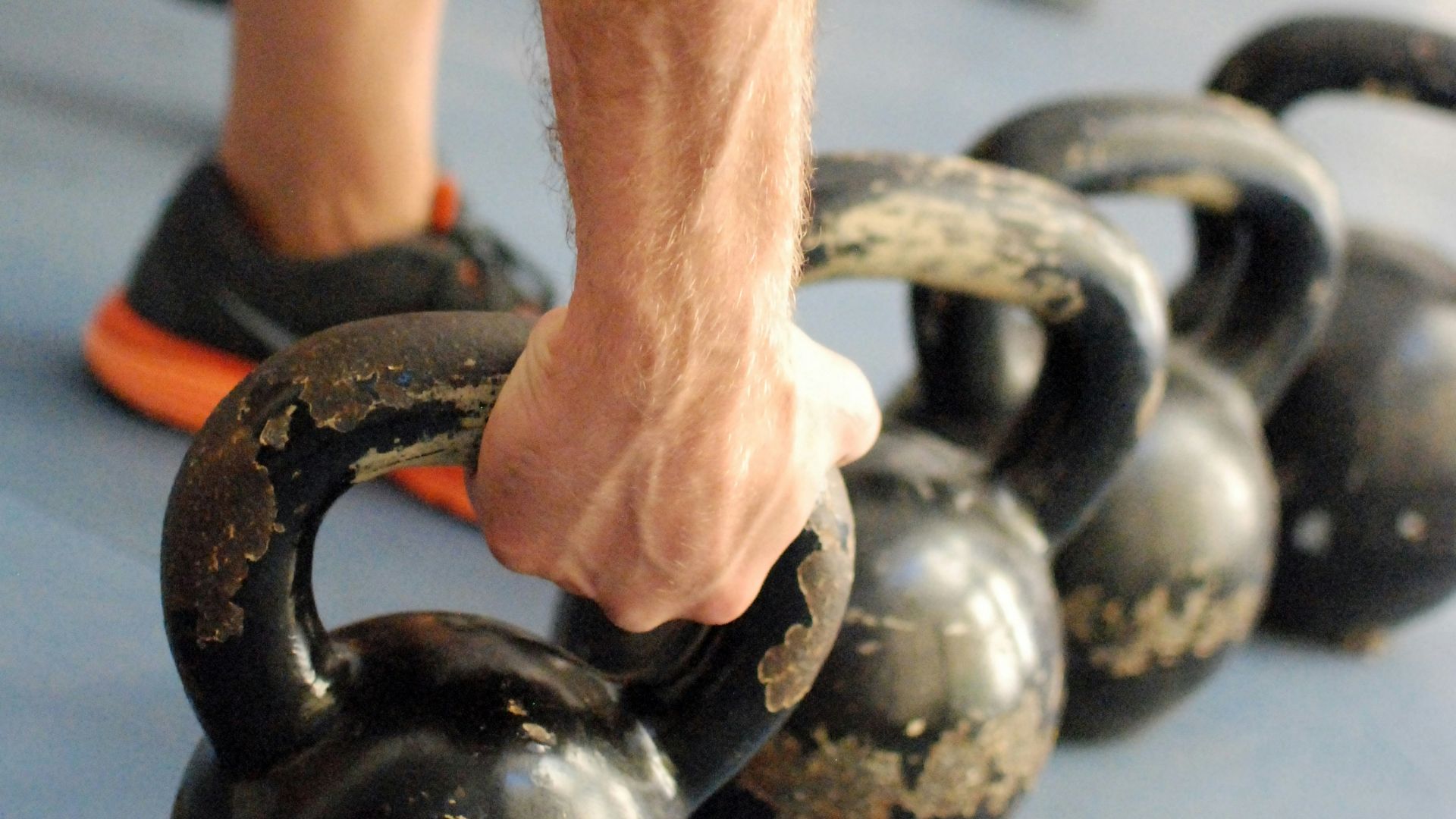 person holding black kettlebell