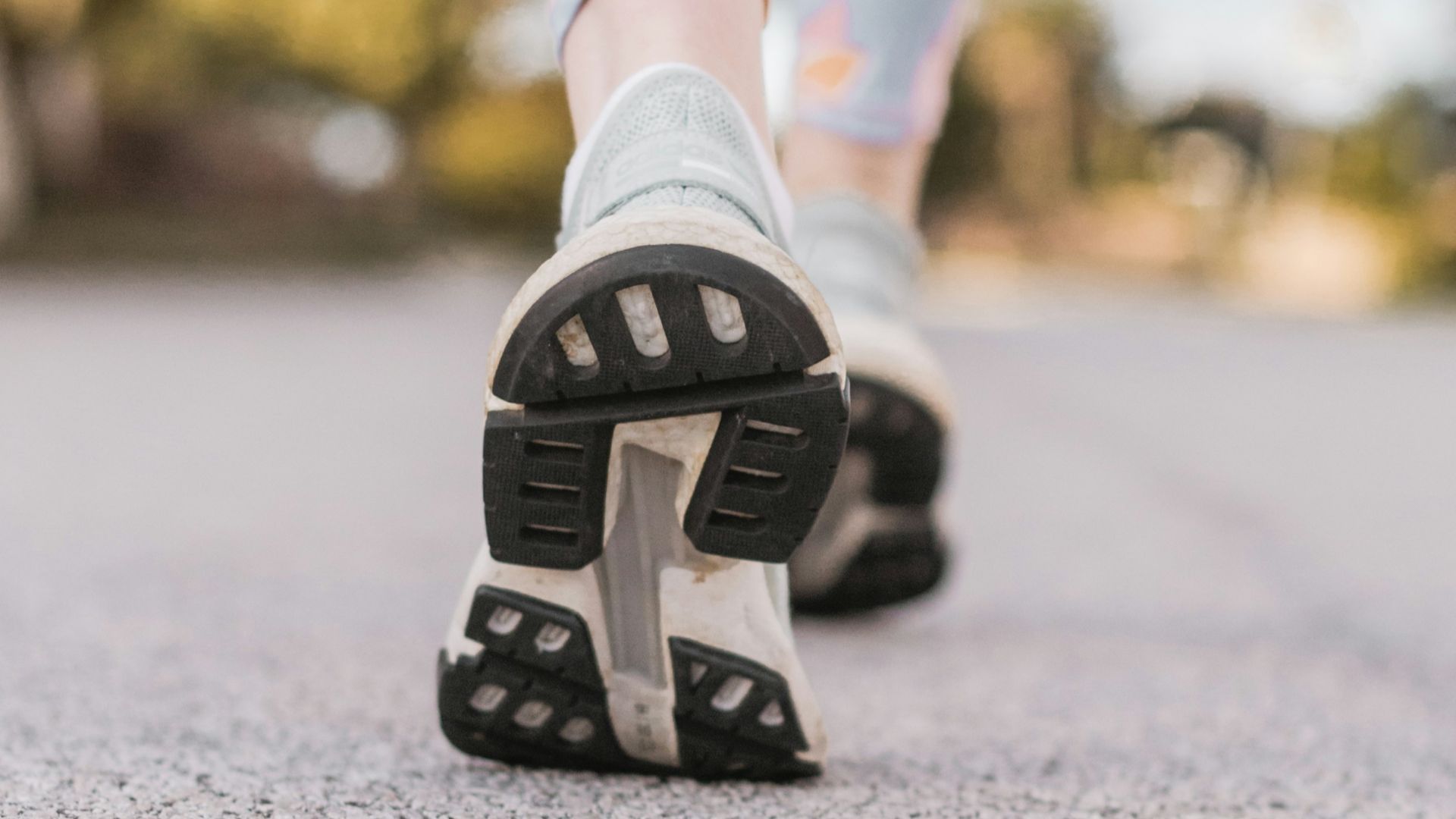 person wearing black and white nike shoes