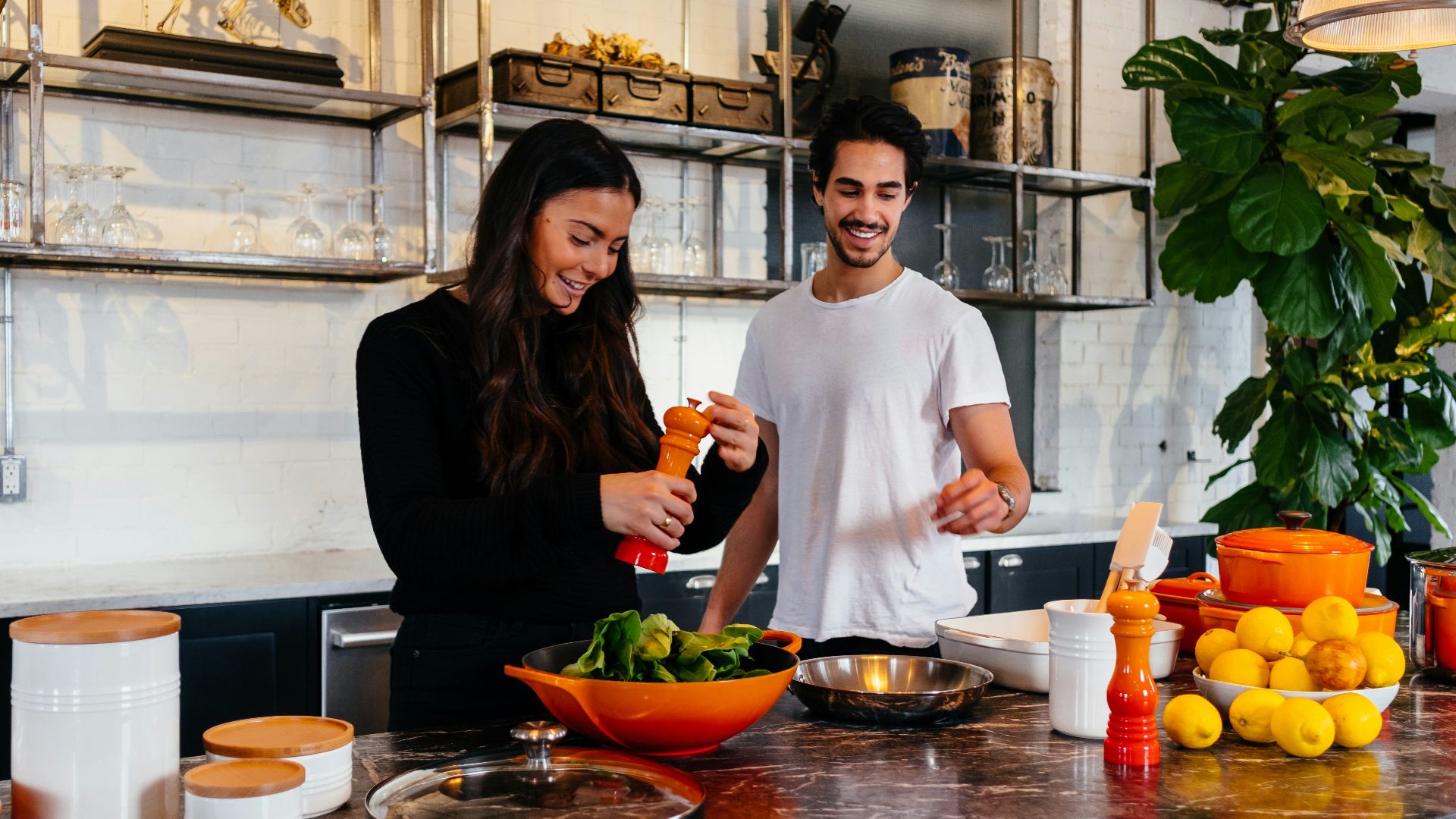man and woman standing in front of table