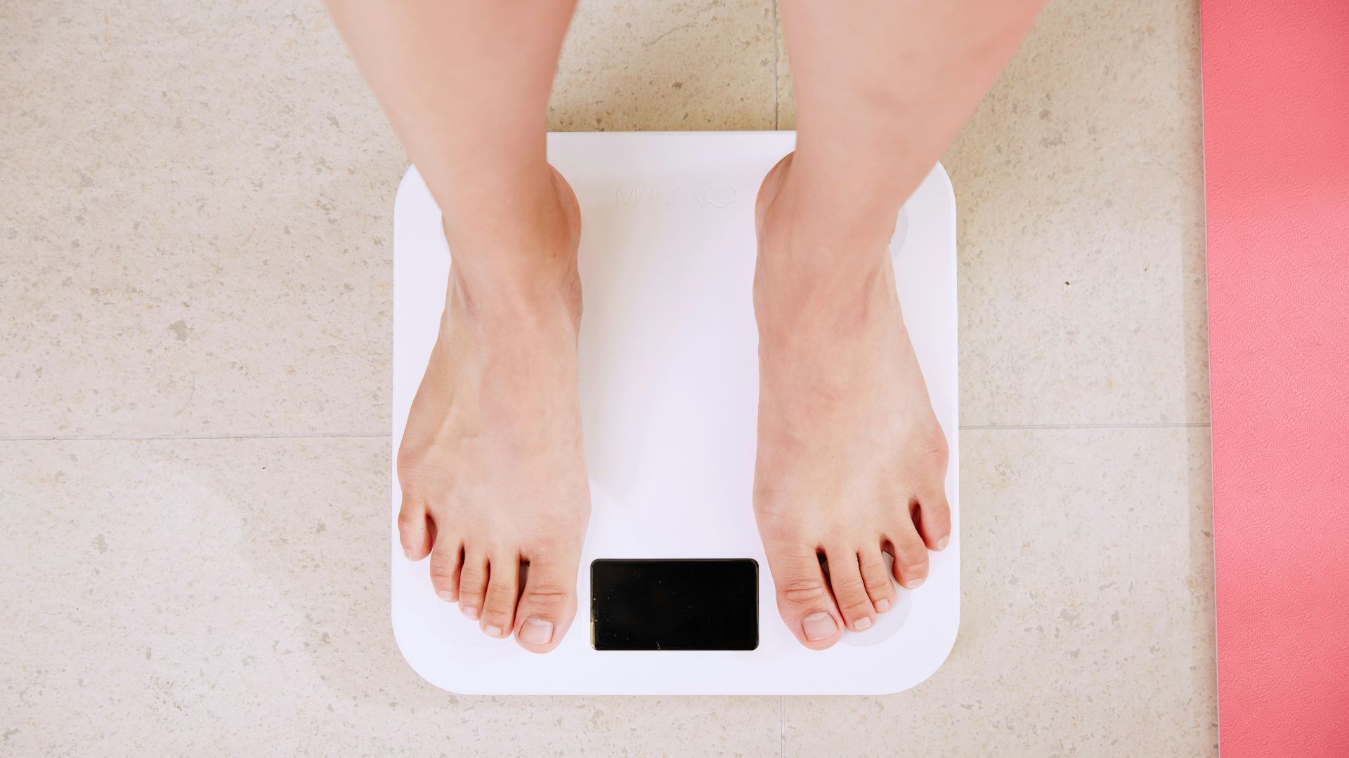 person standing on white digital bathroom scale