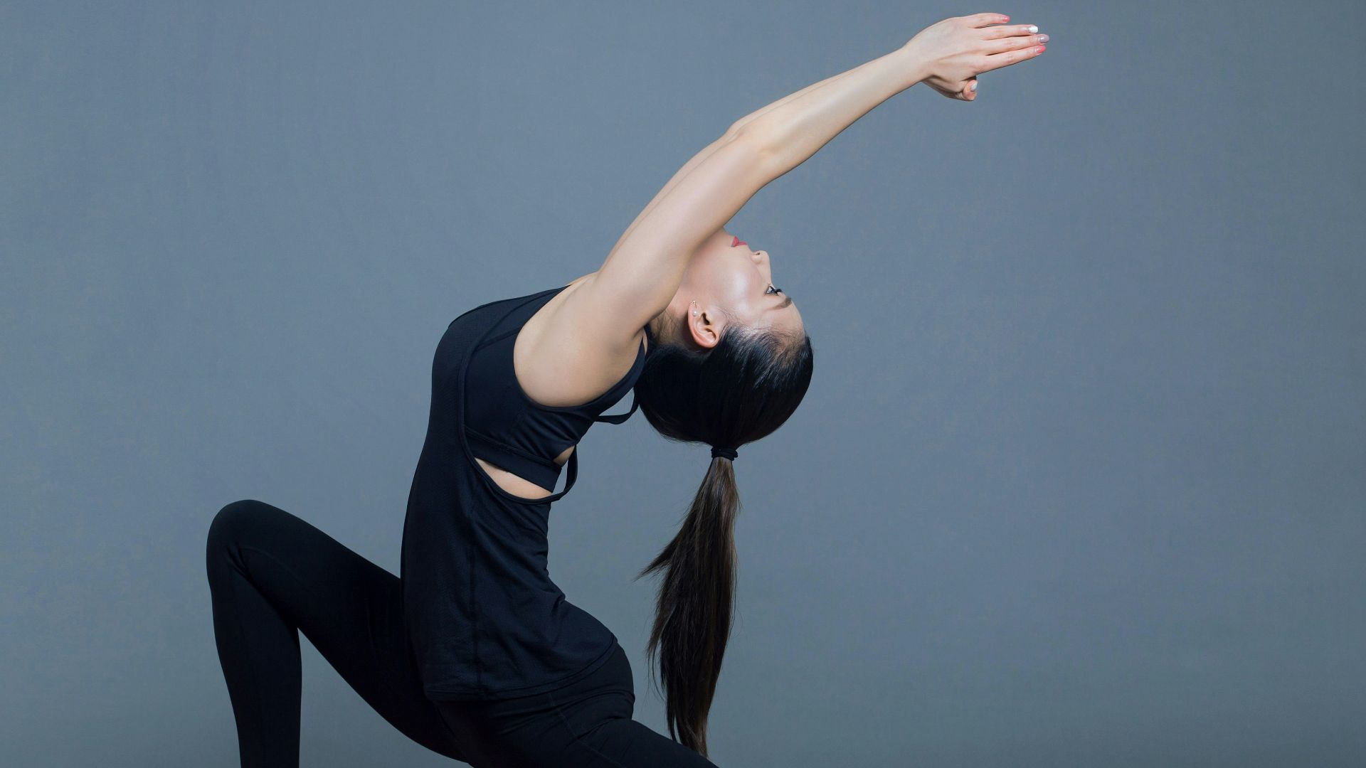 woman in black tank top and black pants doing yoga