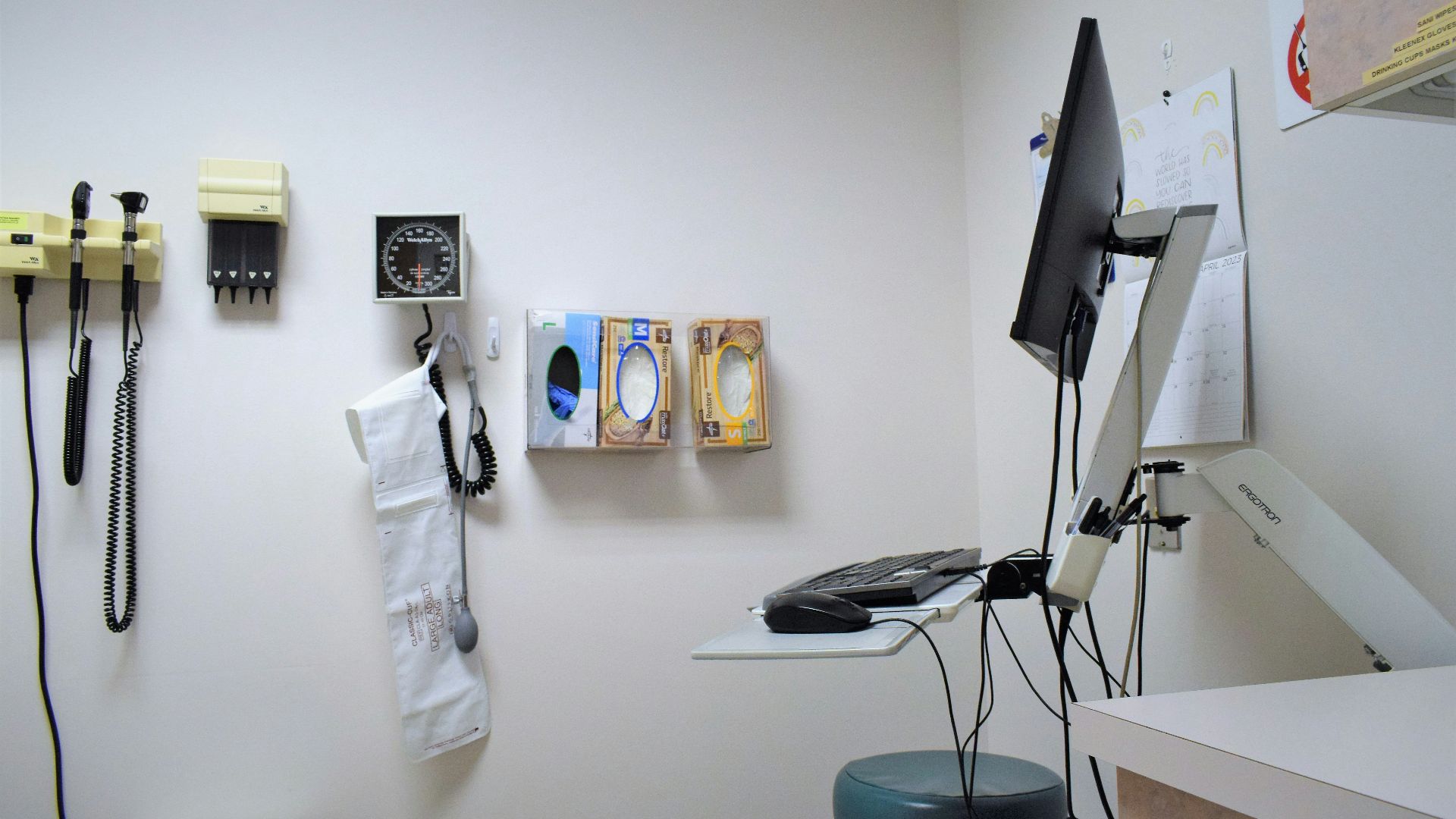 a room with a desk, phone, and other items on the wall