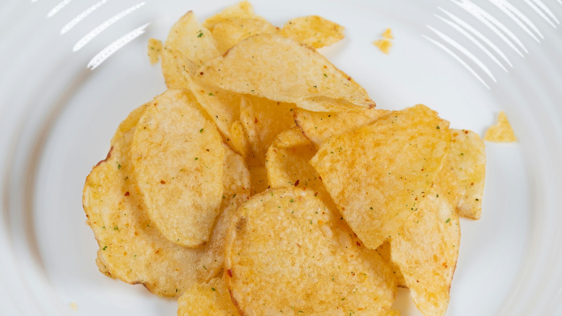 a white plate topped with chips on top of a table