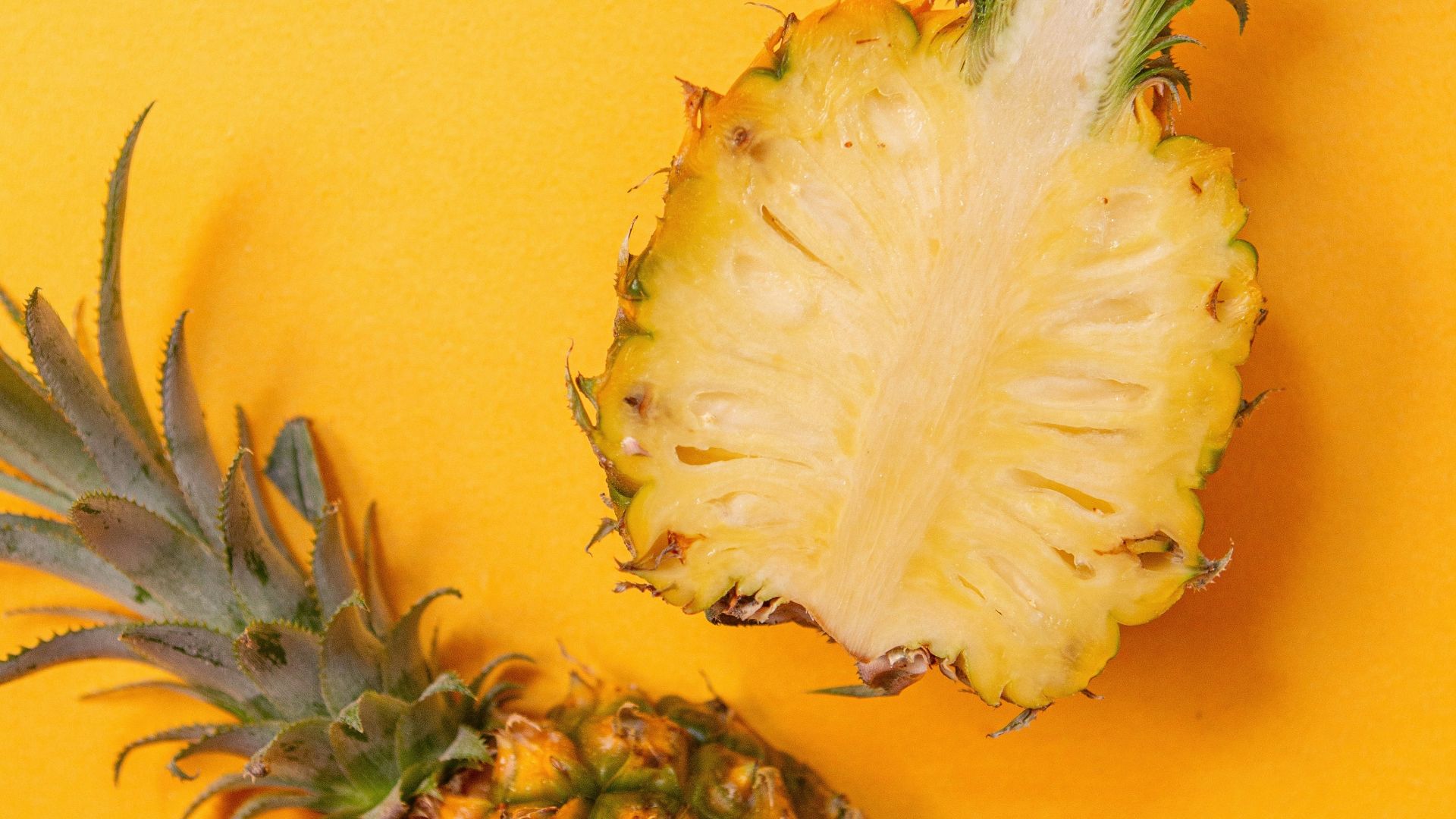 pineapple fruit on yellow surface