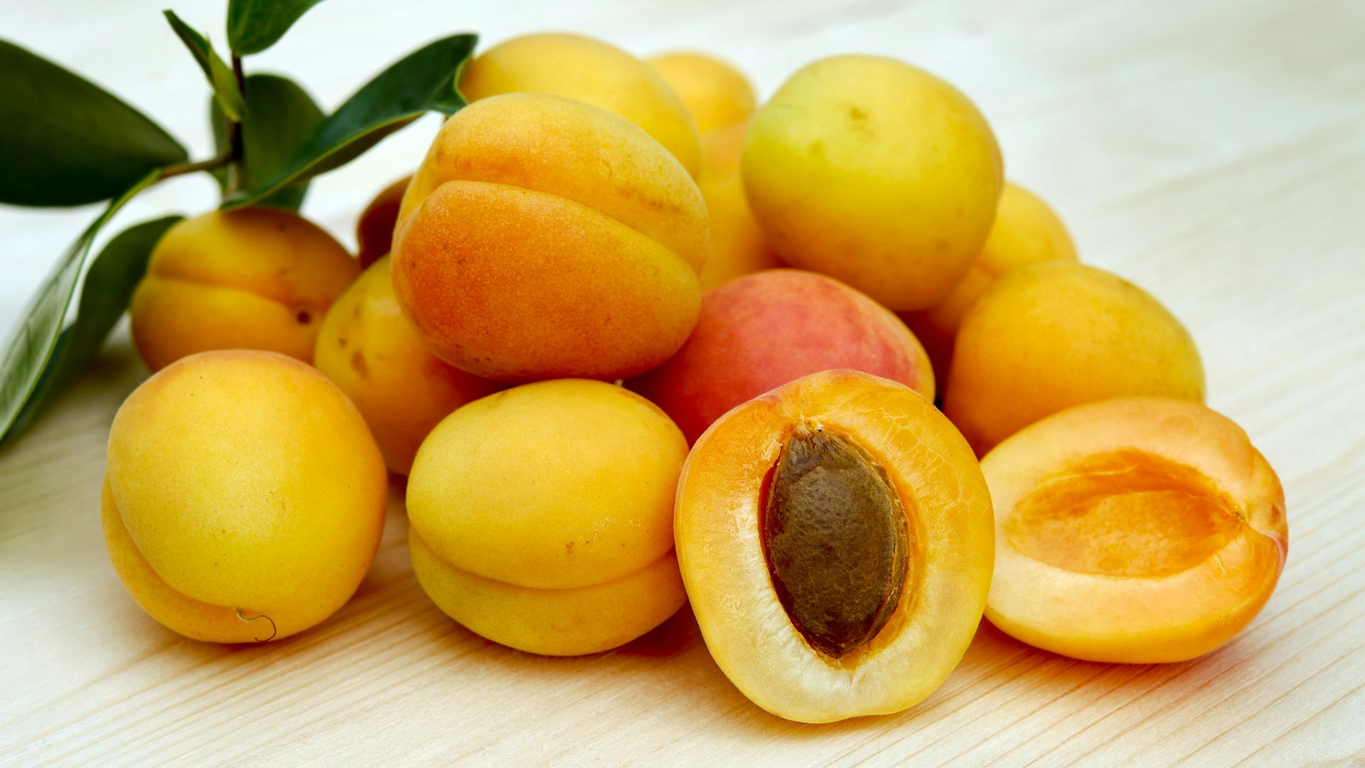 yellow round fruits on white table