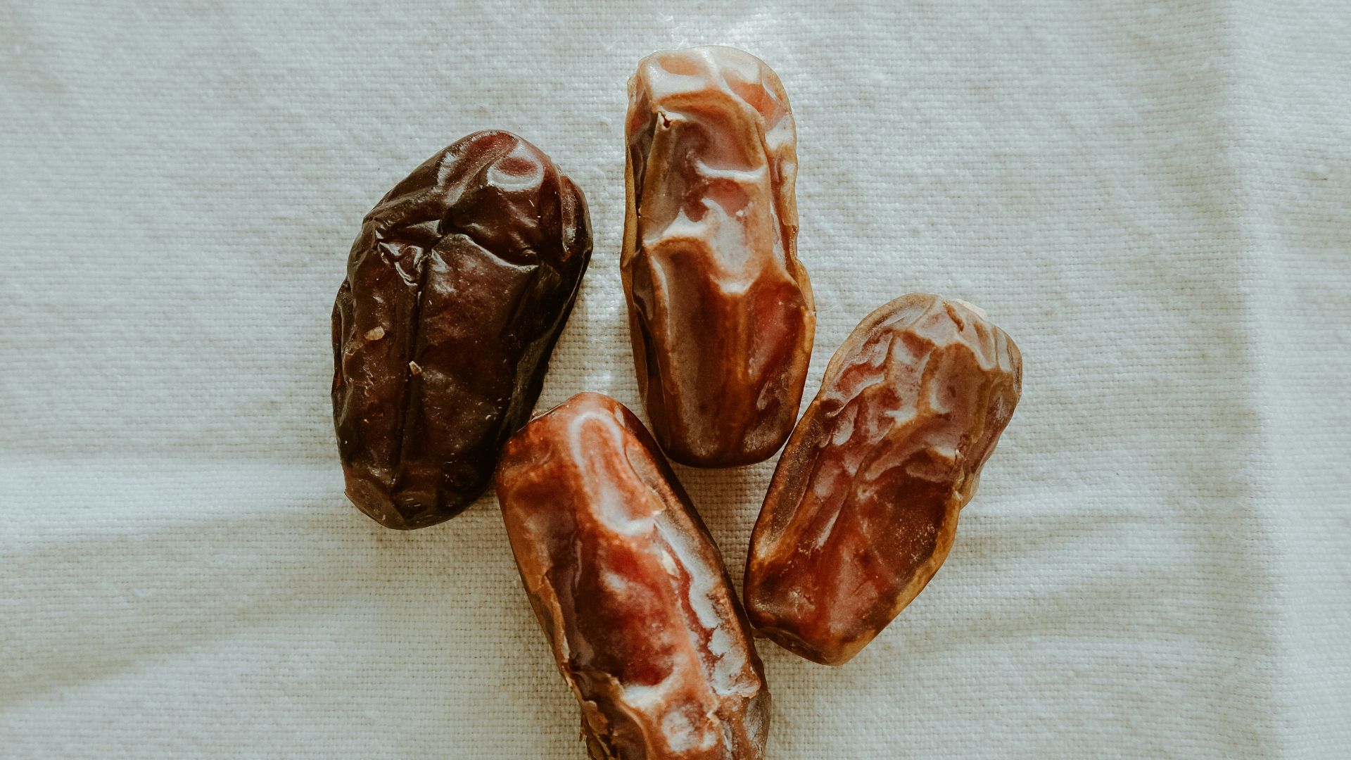 four dates sitting on top of a white towel