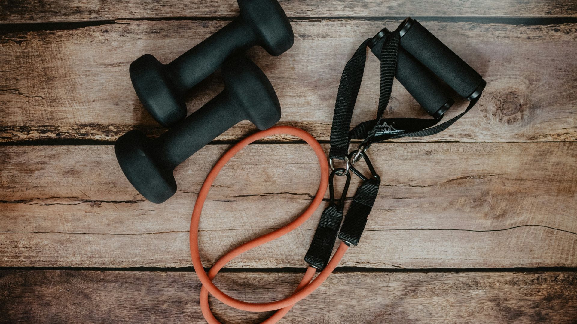 orange and black usb cable on brown wooden surface
