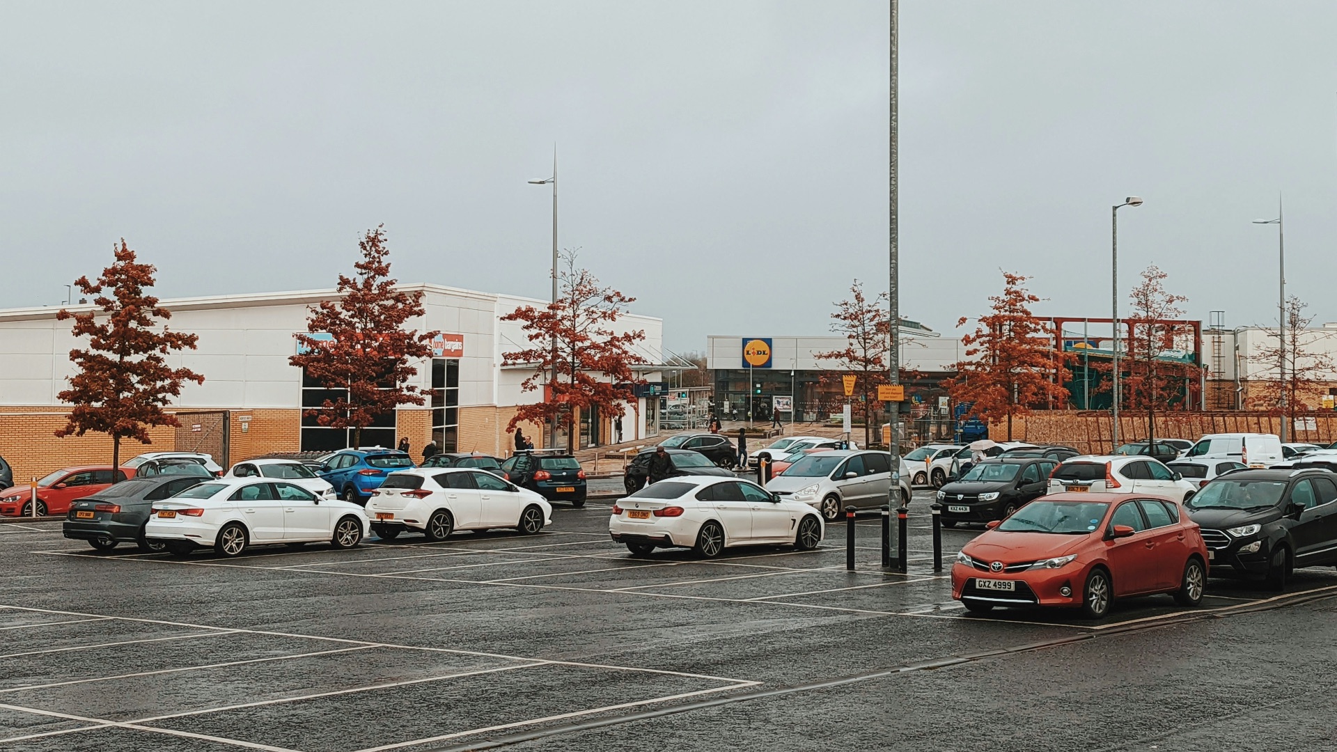 a parking lot filled with lots of parked cars
