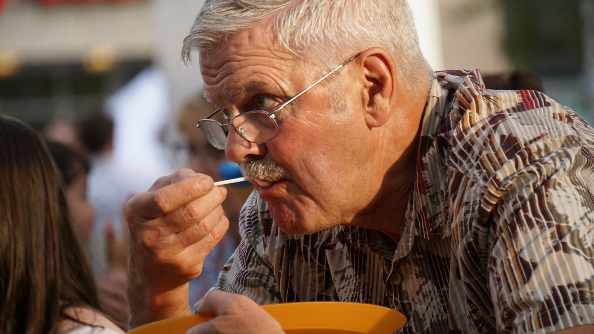 man in brown and black plaid button up shirt smoking cigarette