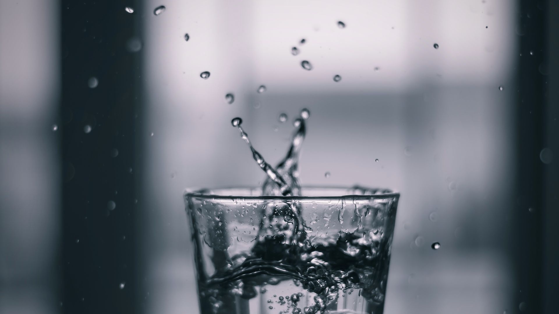 water pouring on clear drinking glass