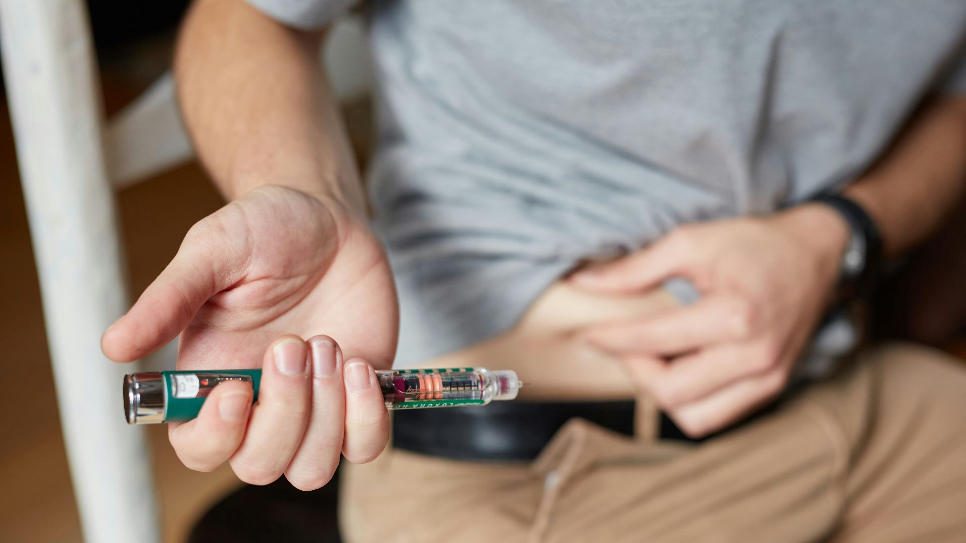 a person holding an insulin injection