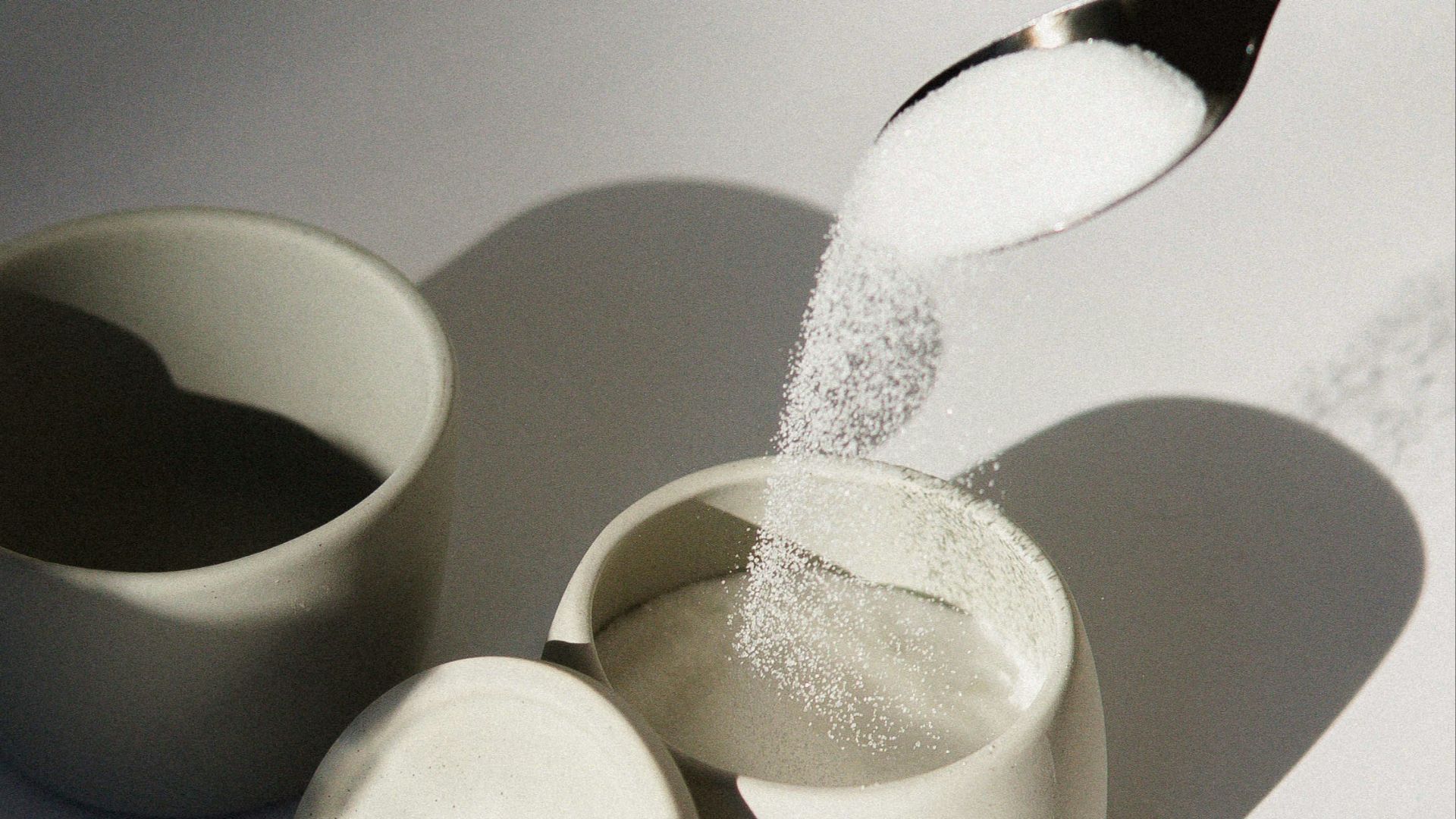white ceramic mugs on white table