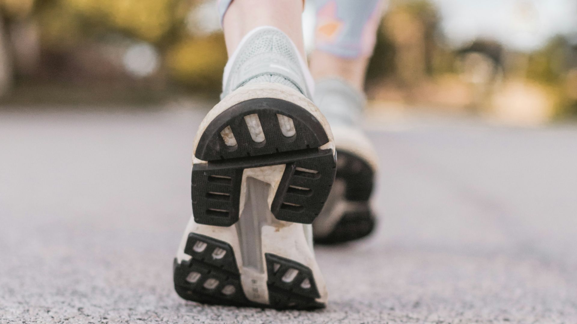 person wearing black and white nike shoes