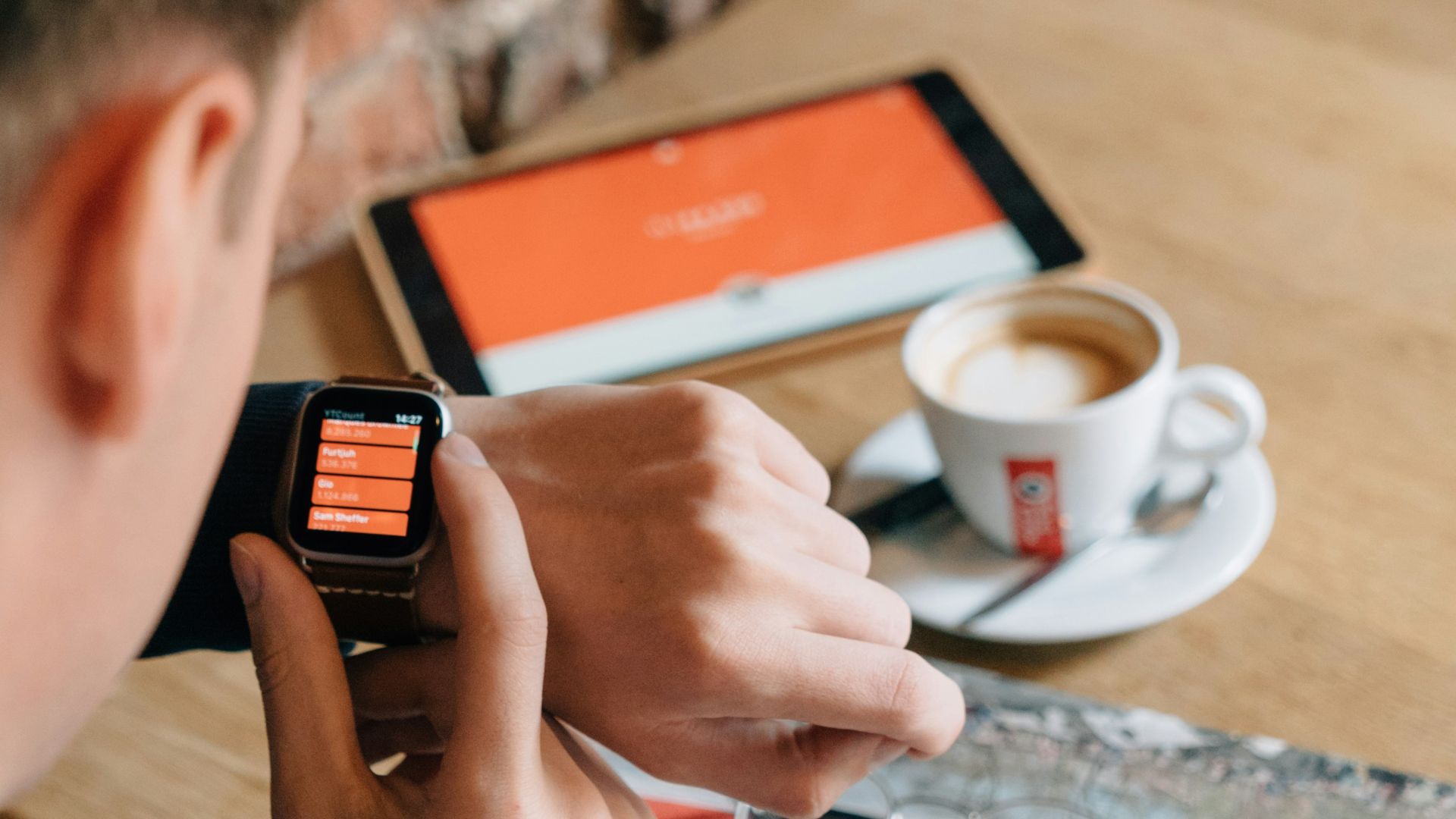 man sitting in front of table with teacup and paper