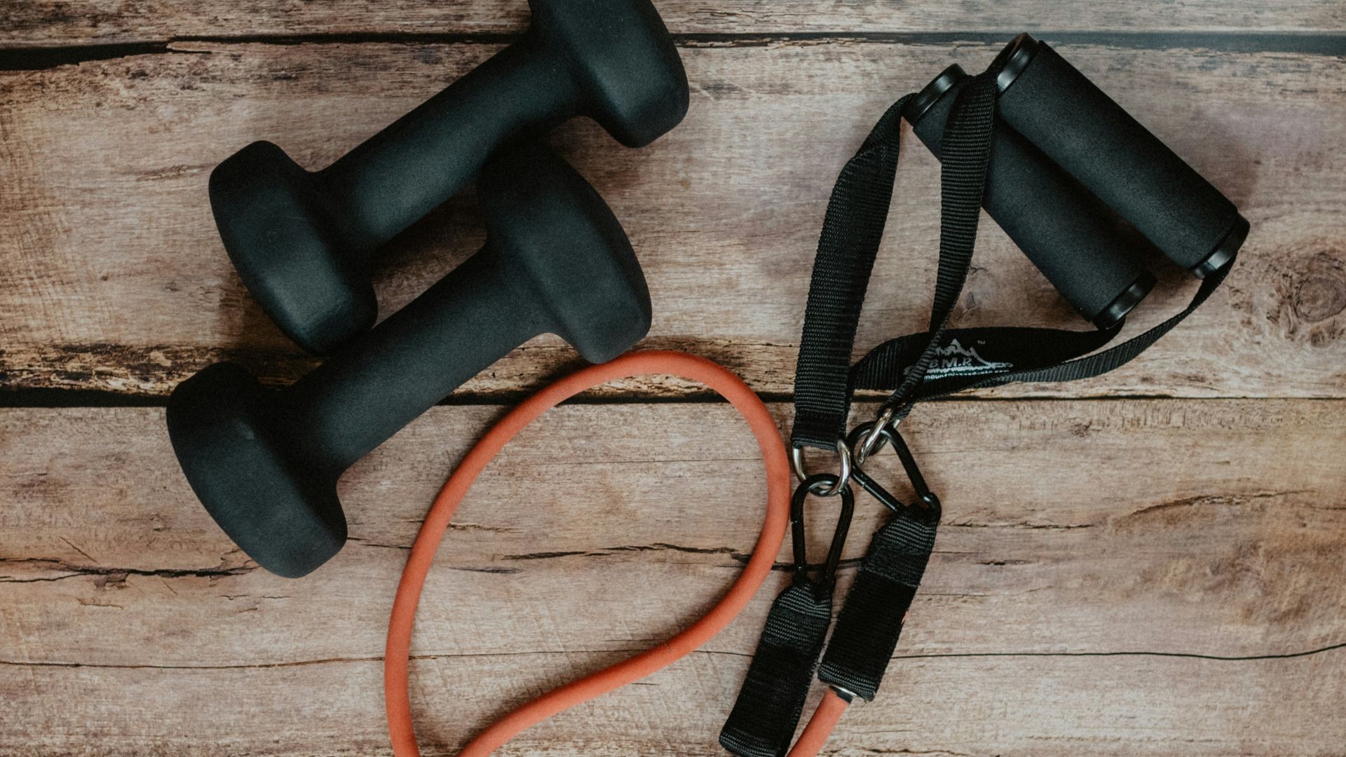 orange and black usb cable on brown wooden surface