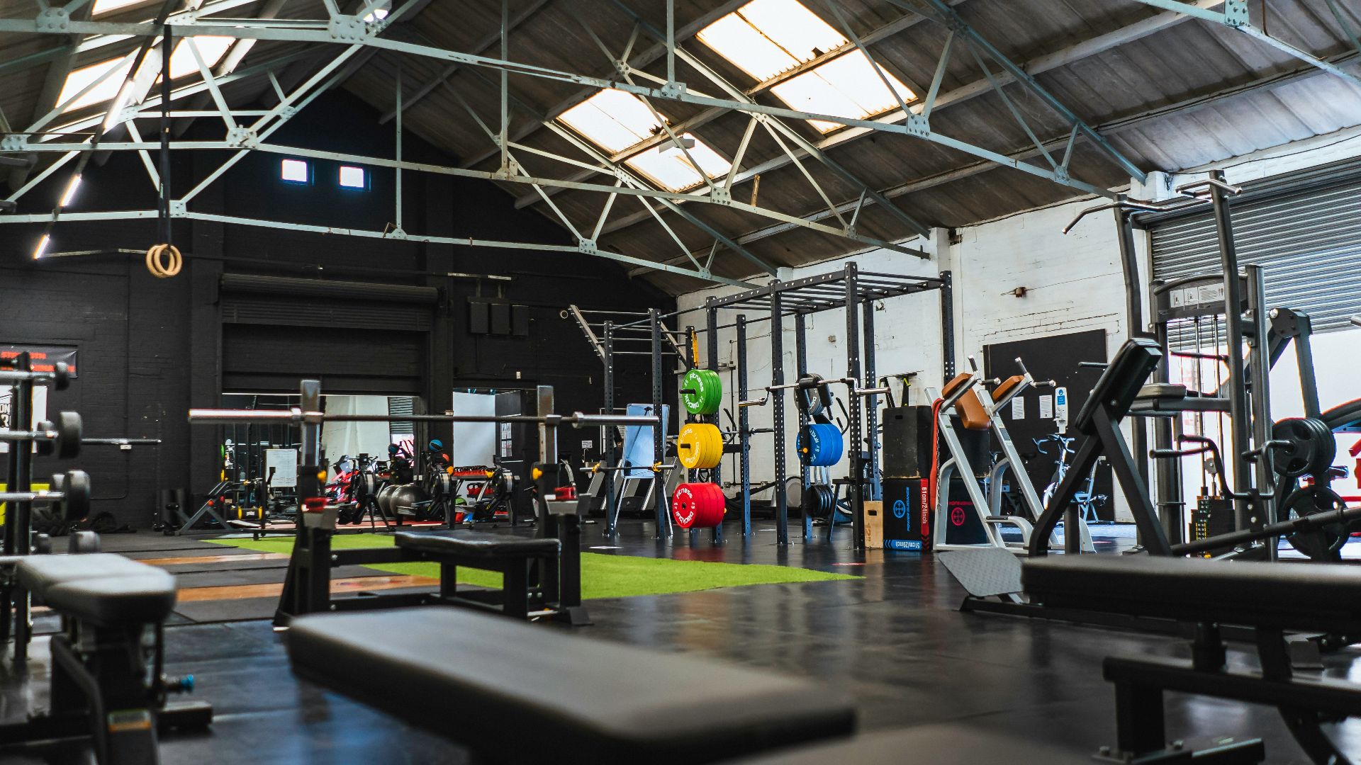 people in a room with a black table and chairs