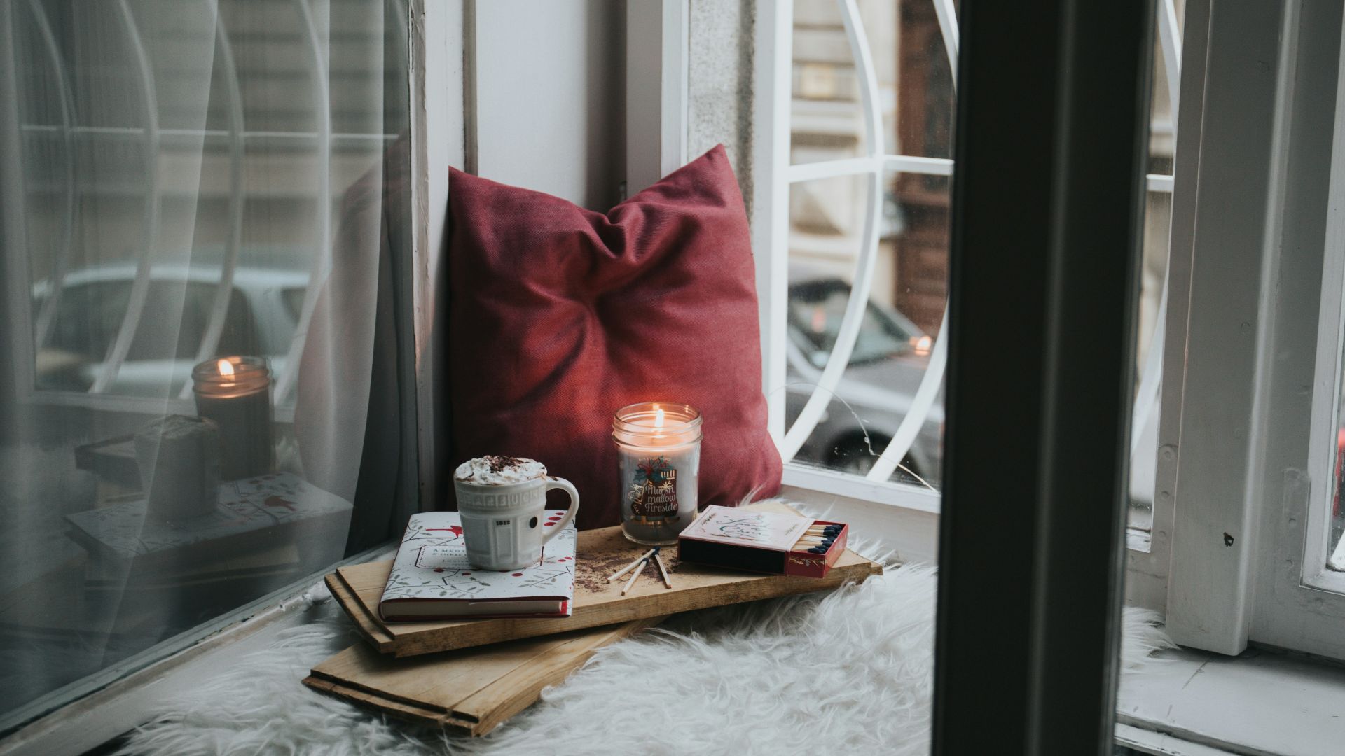 photo of gel candle on board beside pillow