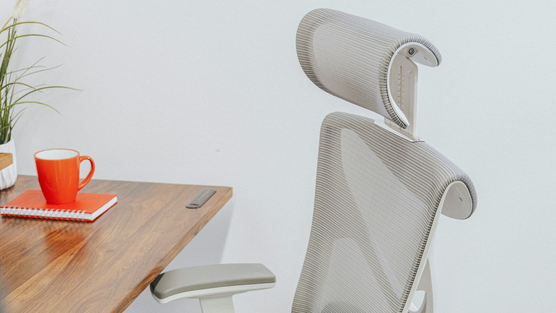 a gray office chair sitting next to a wooden table