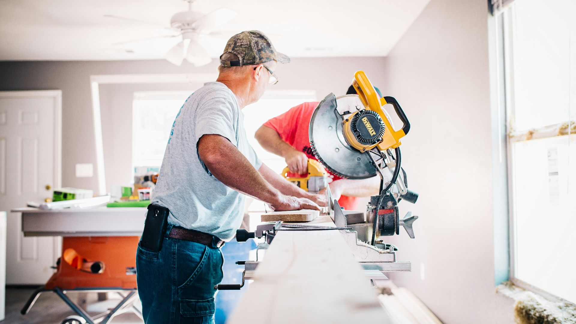 man standing infront of miter saw