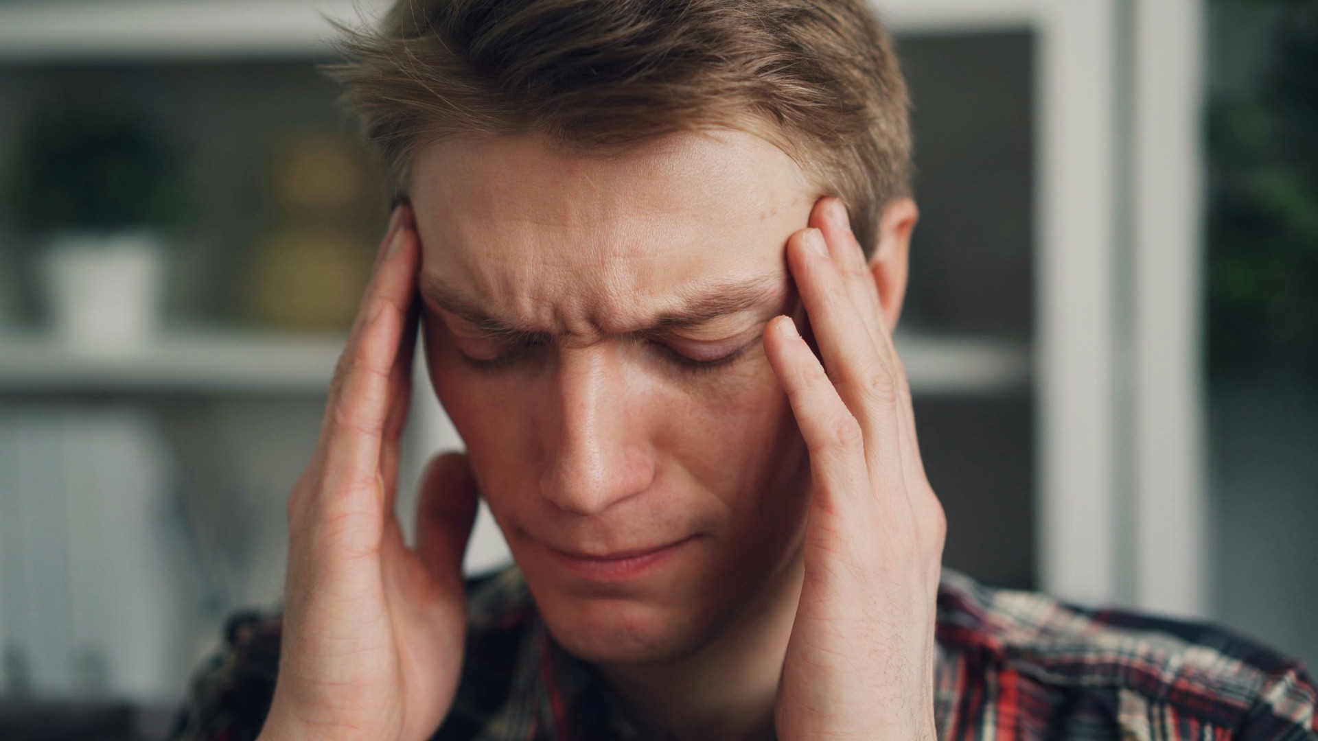 a man holding his hands to his ears