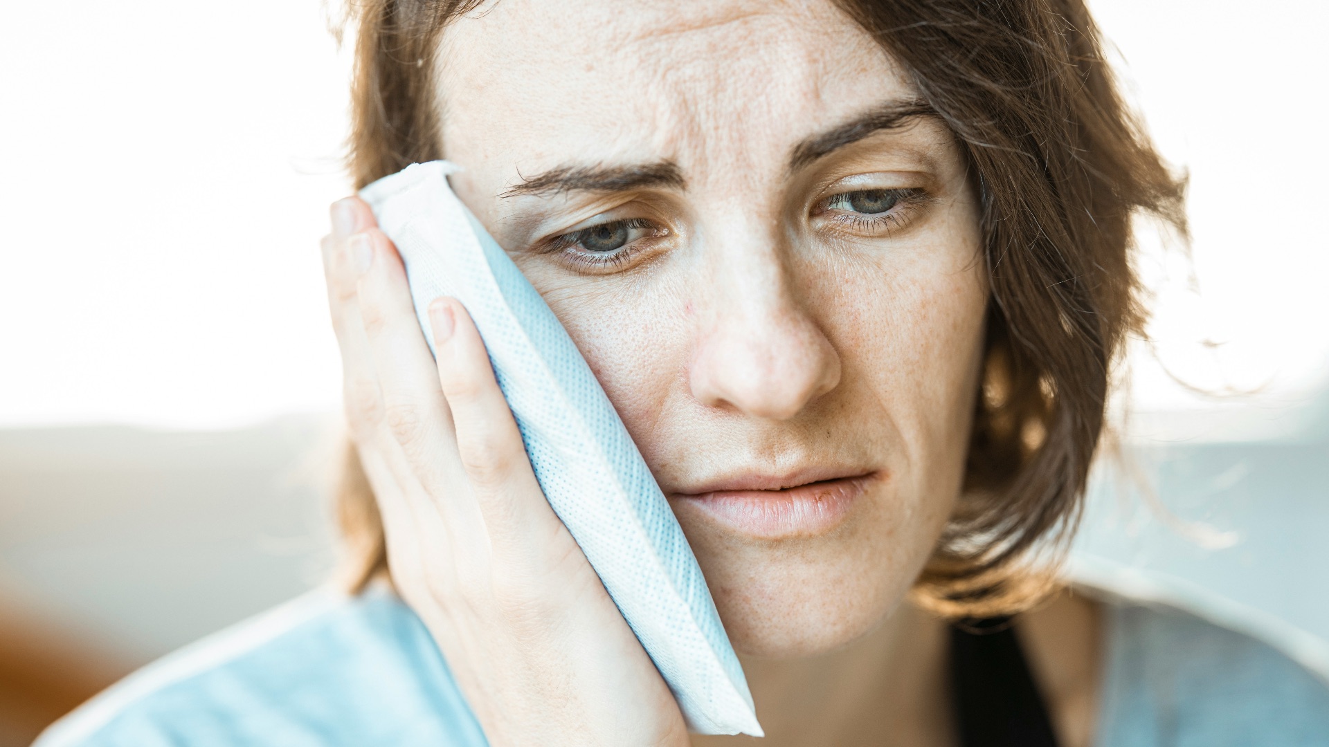 woman in black tank top holding white textile
