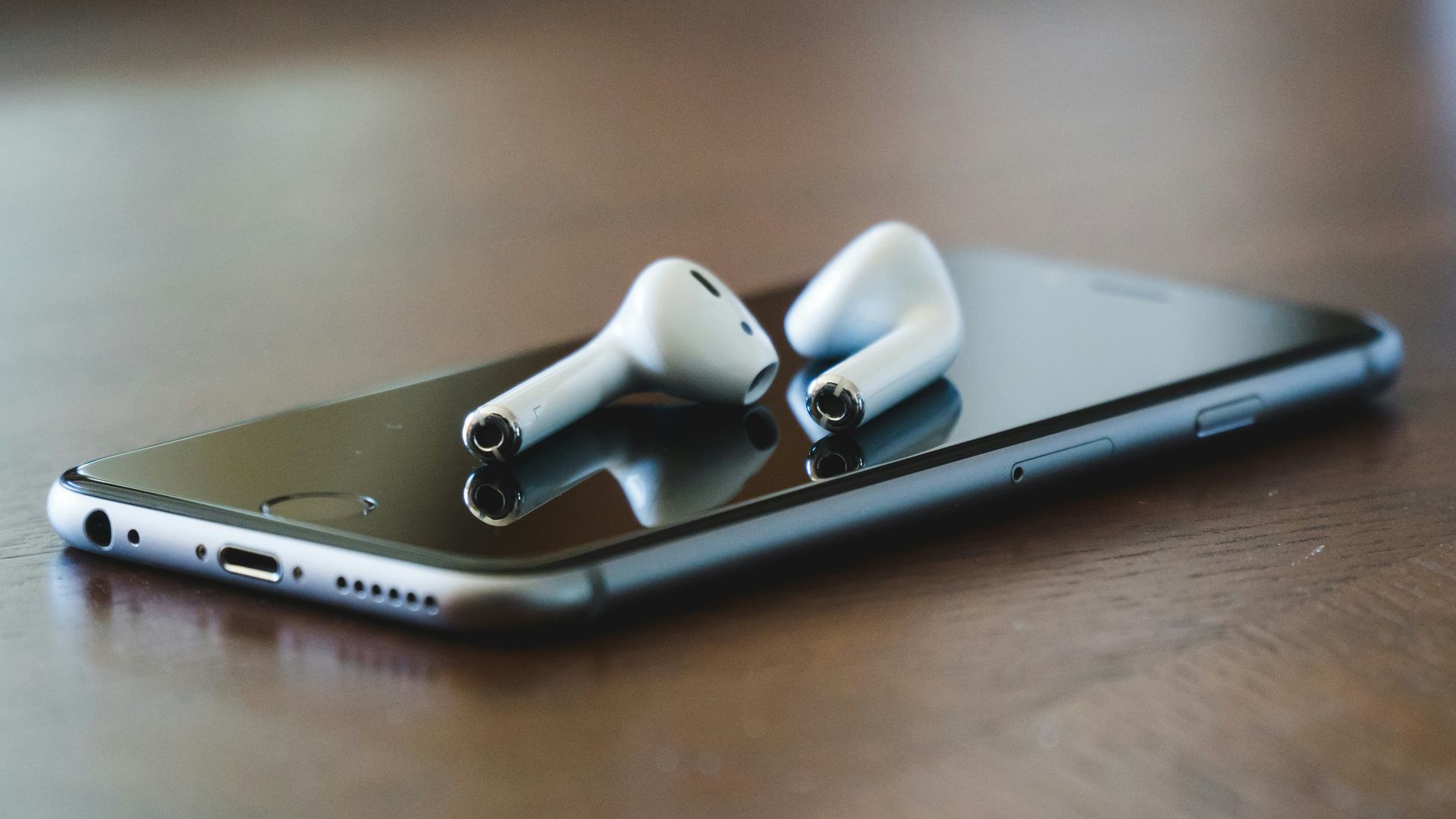 silver iphone 6 on brown wooden table