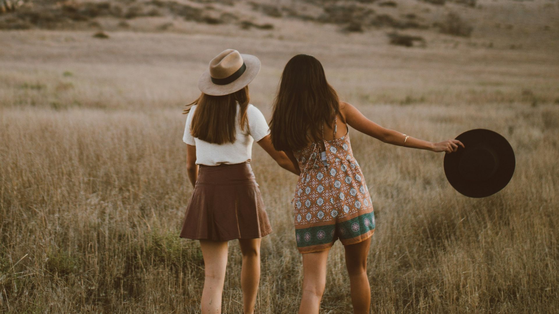 two women walking around near mountain at daytime