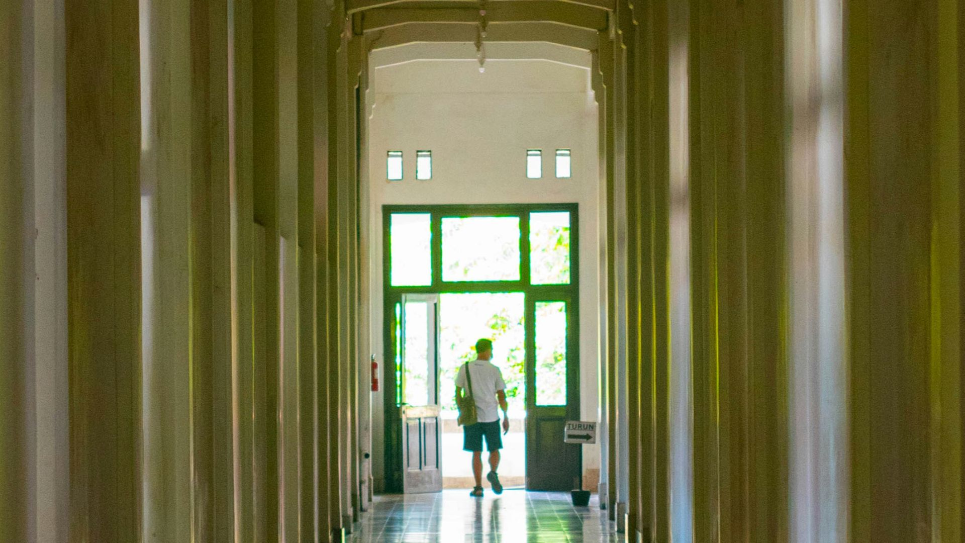 A long hallway with a clock on the wall