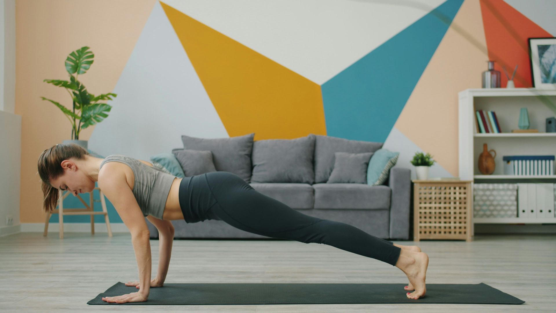 Woman doing a plank exercise on a yoga mat.