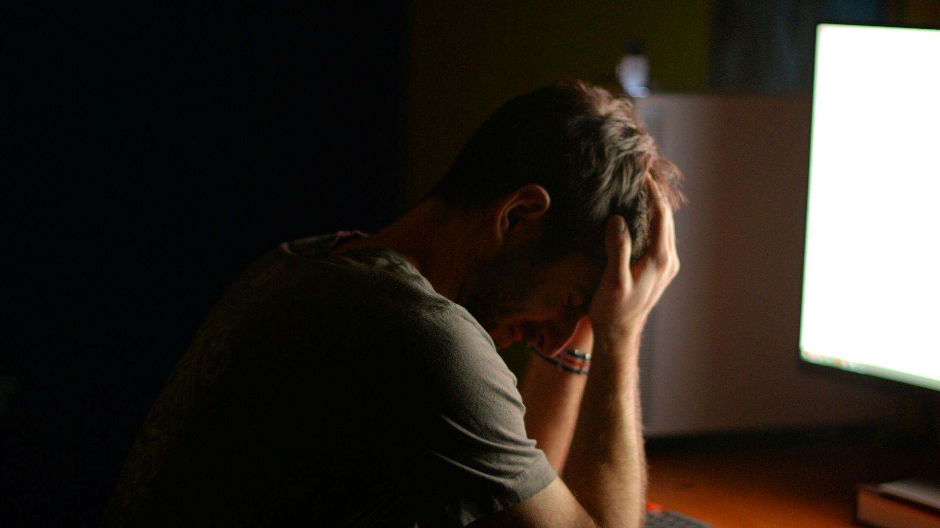 a man sitting at a desk in front of a computer