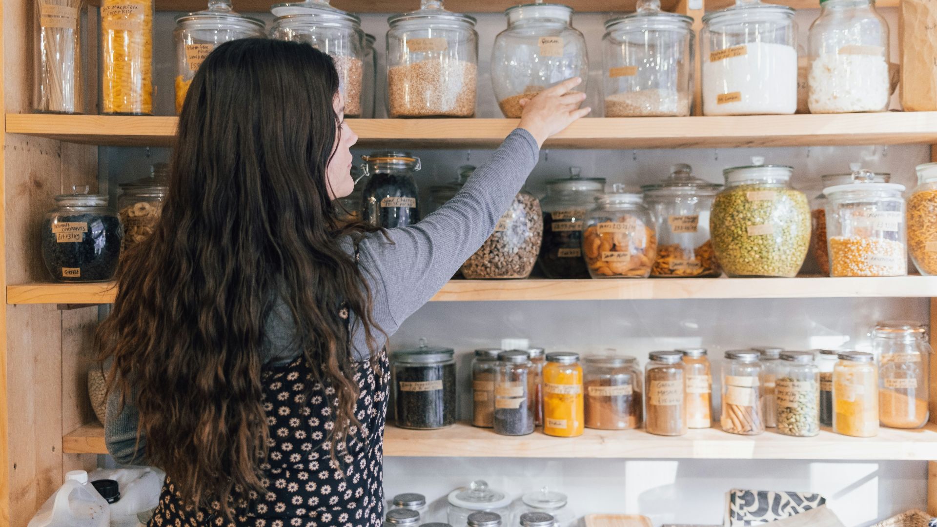 a person holding a jar of food