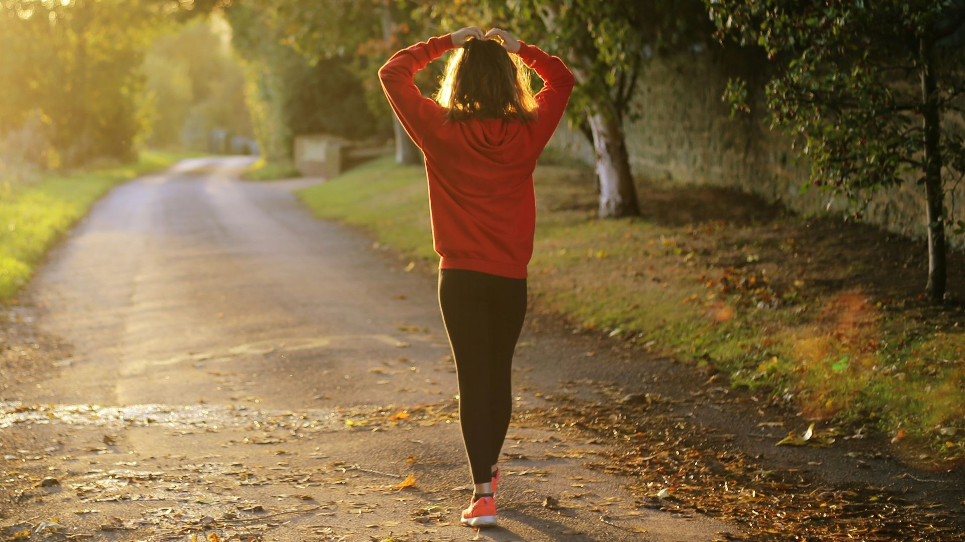 woman walking on pathway during daytime